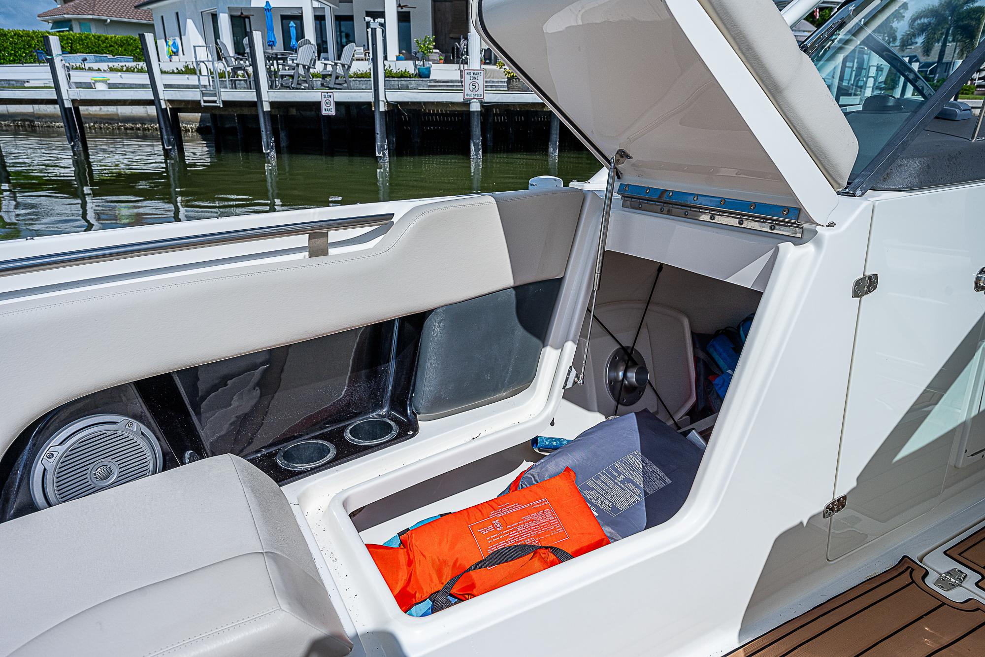 2018 Boston Whaler 270 Vantage boat with open storage compartment and life jacket.