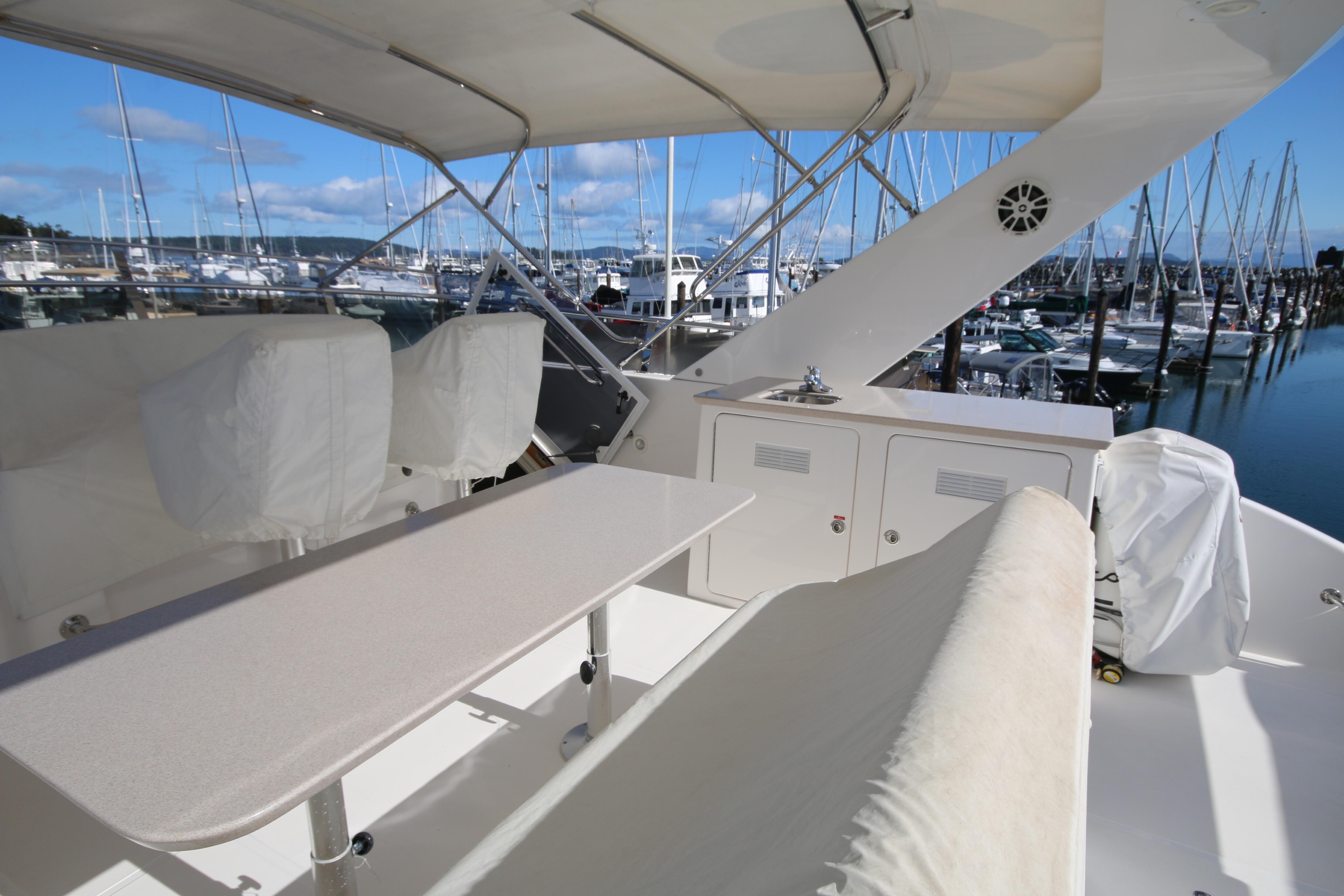 Luxurious 2004 West Bay 68 Sonship Pilothouse yacht interior with marina view.