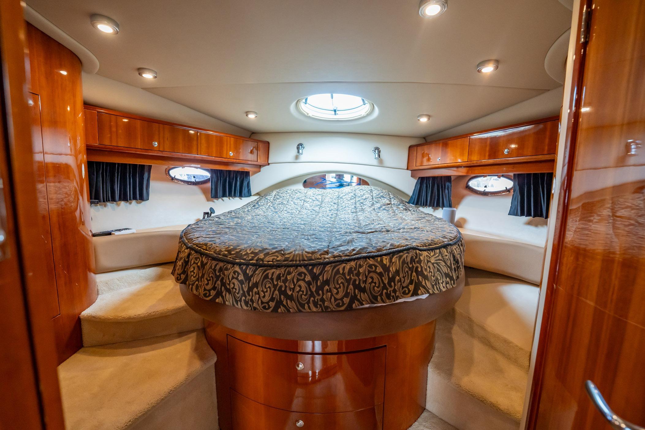 Luxurious cabin interior of 2008 Regal Commodore 4460 yacht with elegant wood finish.