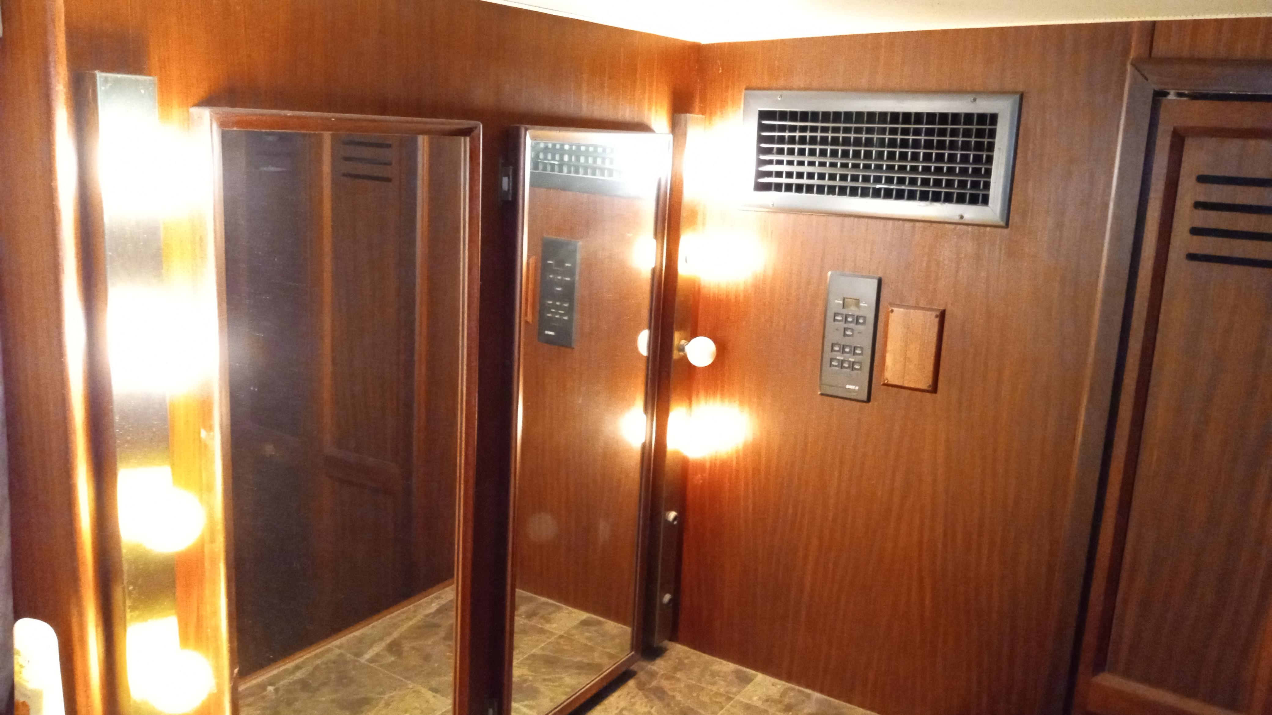 Interior of 1986 Hatteras 53 Extended Deckhouse Motor Yacht with wood paneling and mirrors.