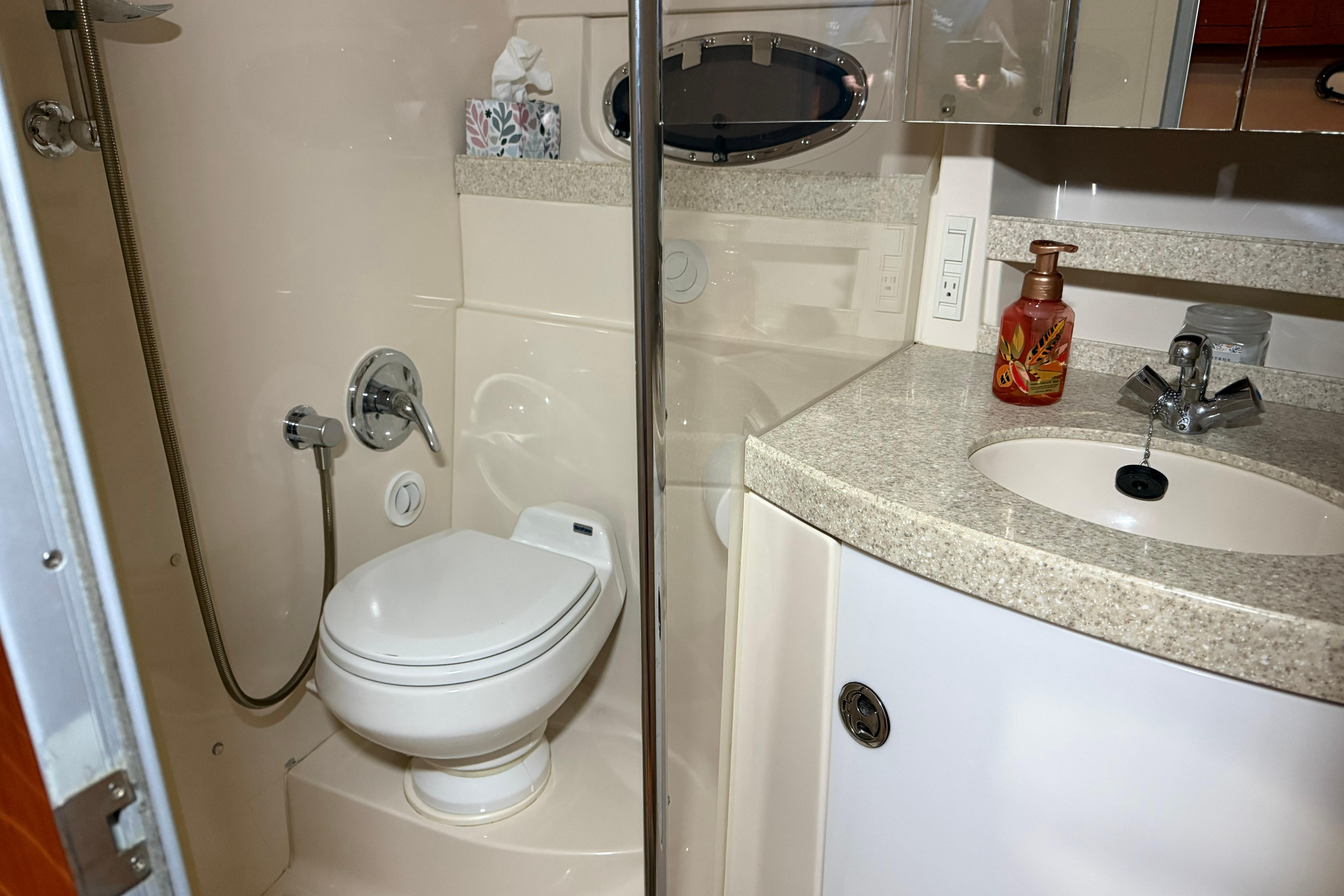 2007 Regal Commodore 3760 IO yacht bathroom with toilet, sink, and shower.