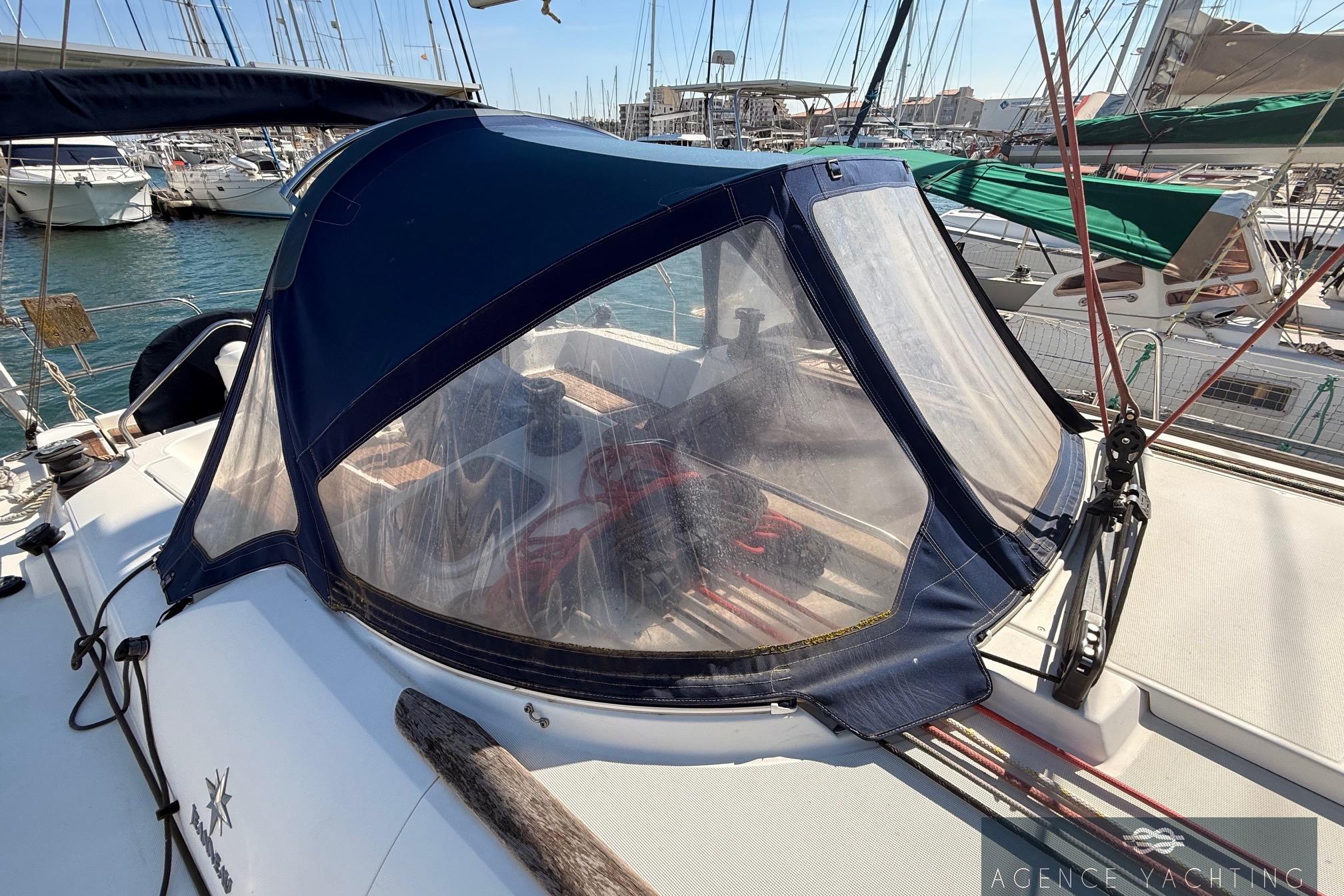 2009 Jeanneau Sun Odyssey 39i Performance sailboat with cockpit cover in marina.
