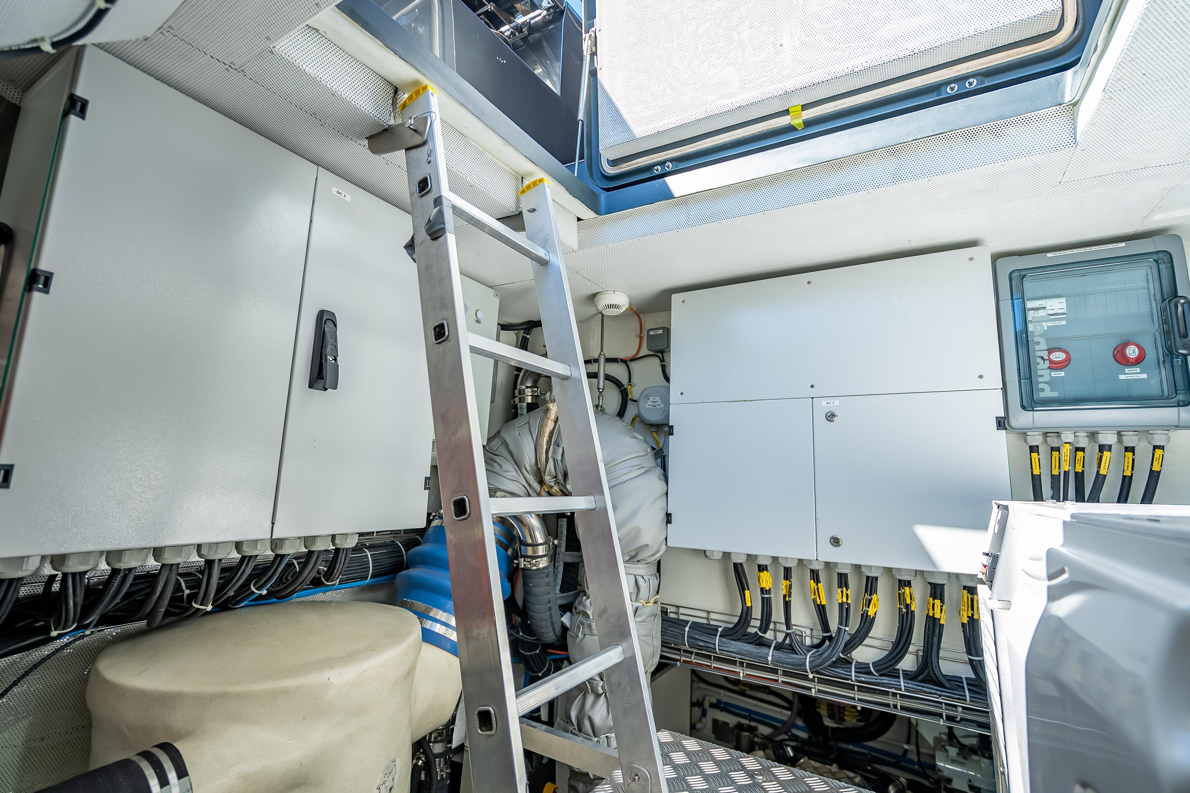 Engine room of 2026 Sunreef 60 Power yacht with control panels and ladder.