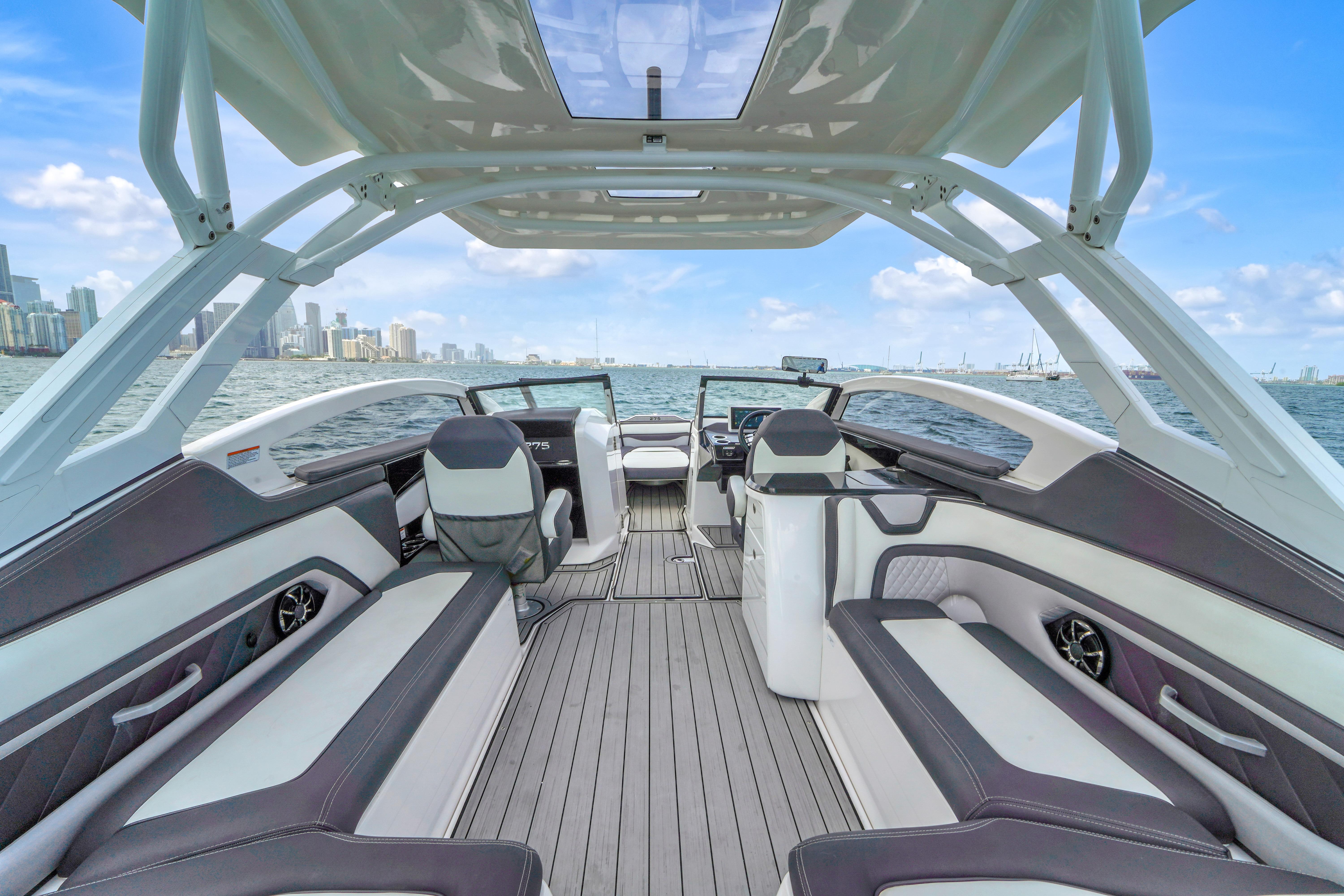 Interior view of 2021 Yamaha Boats 275SD, featuring sleek seating and modern design on open water.