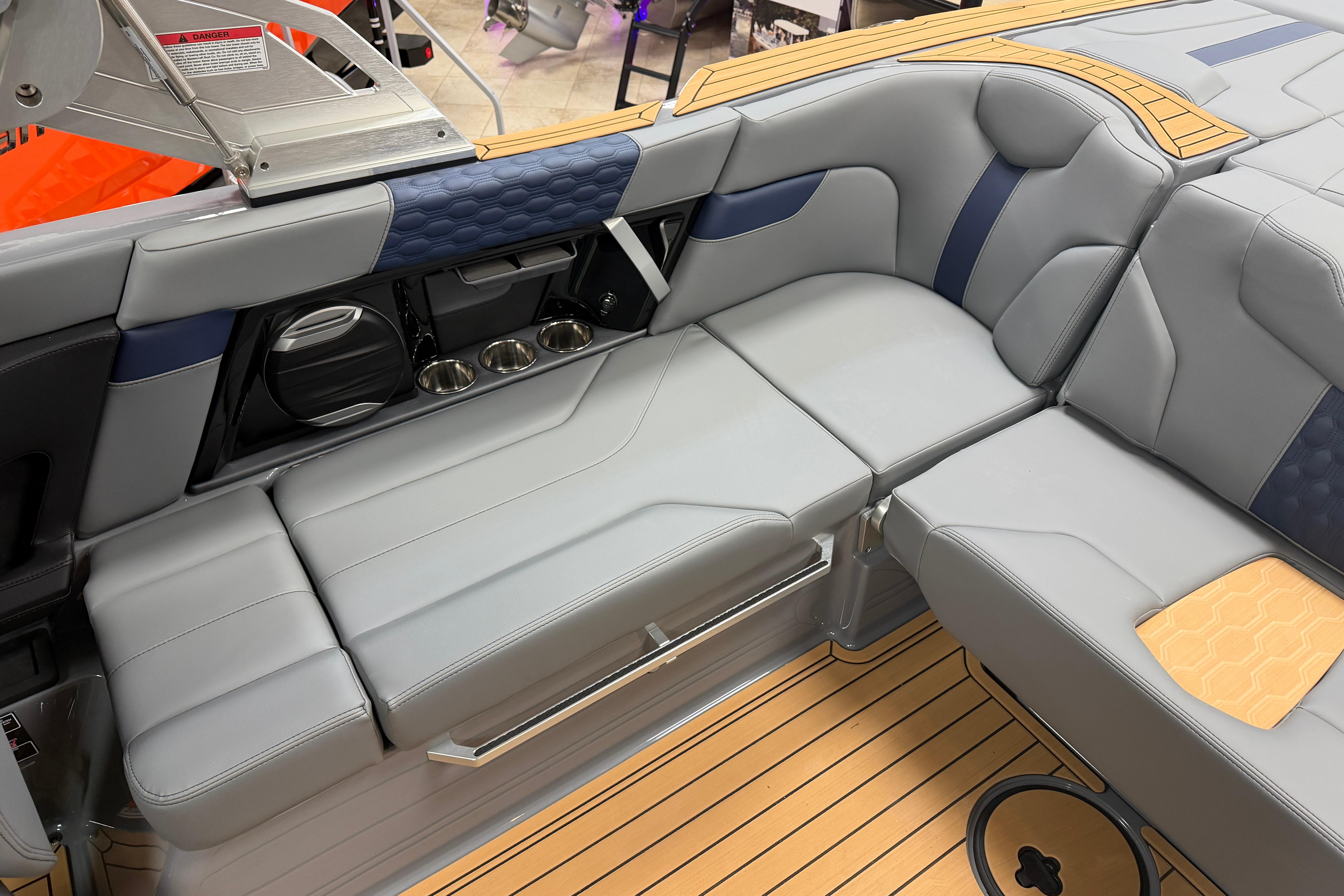 2026 MasterCraft XT22 boat interior with gray seating and teak flooring.