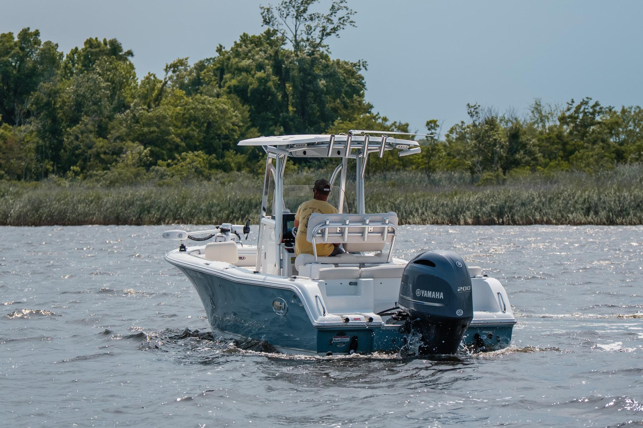 2022 Sea Hunt Ultra 229 boat cruising on a lake with Yamaha engine.