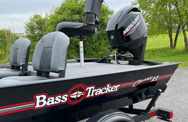 2025 Tracker Bass Tracker Classic XL boat with Mercury engine, parked outdoors.