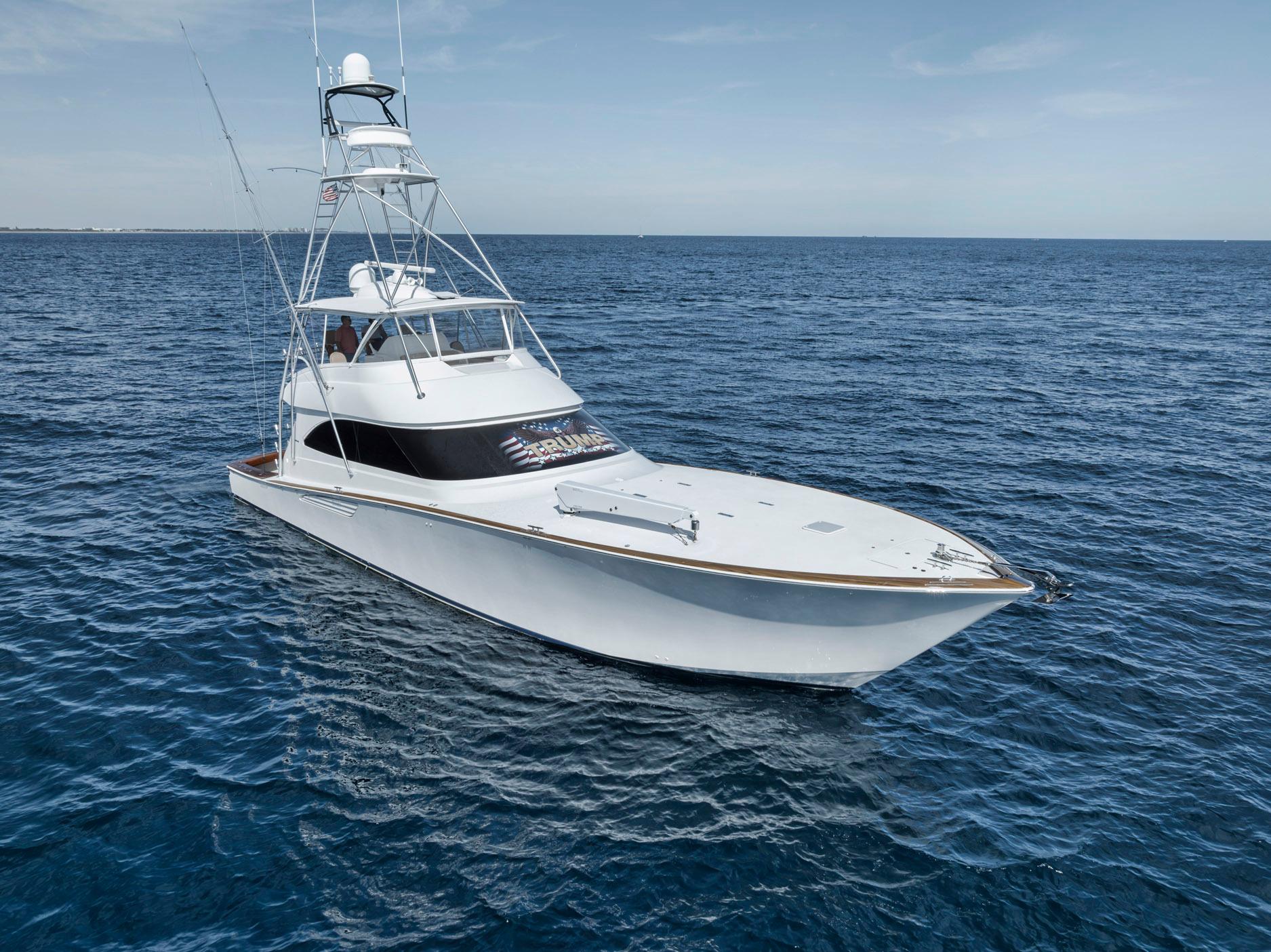 2015 Viking 70 Convertible yacht cruising on open sea.