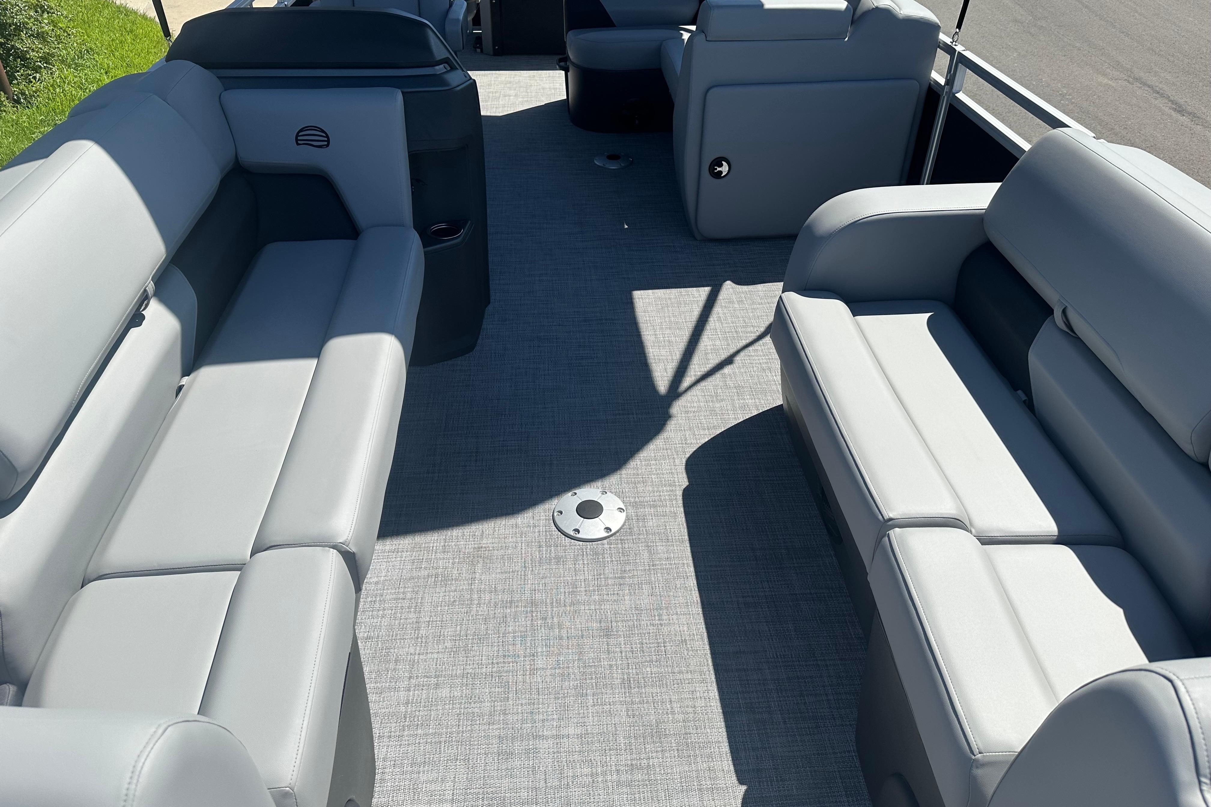 2026 Sun Tracker SportFish 22 DLX interior with spacious gray seating and modern design.