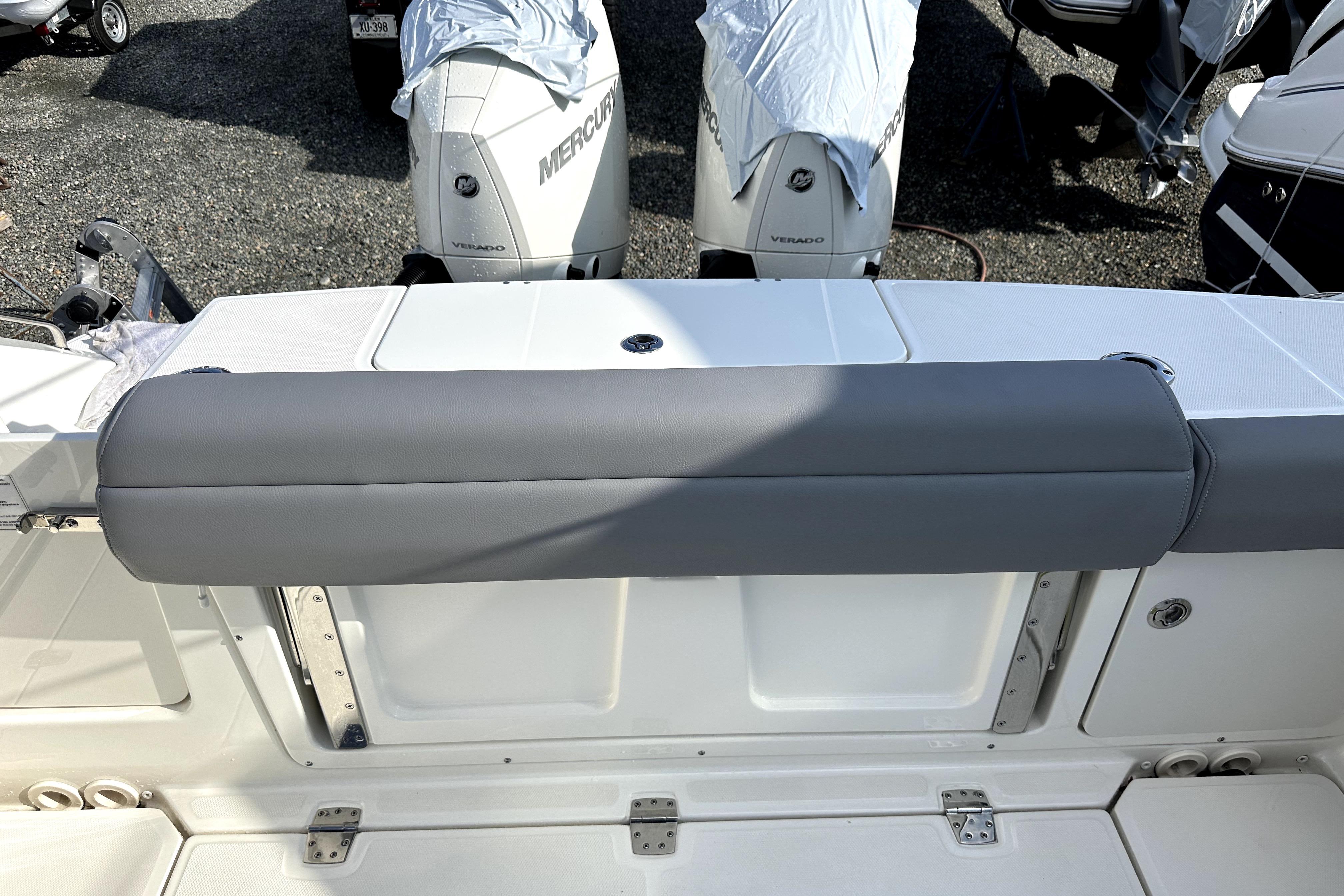 2023 Boston Whaler OUTRAGE boat with Mercury Verado engines, featuring a cushioned seating area.