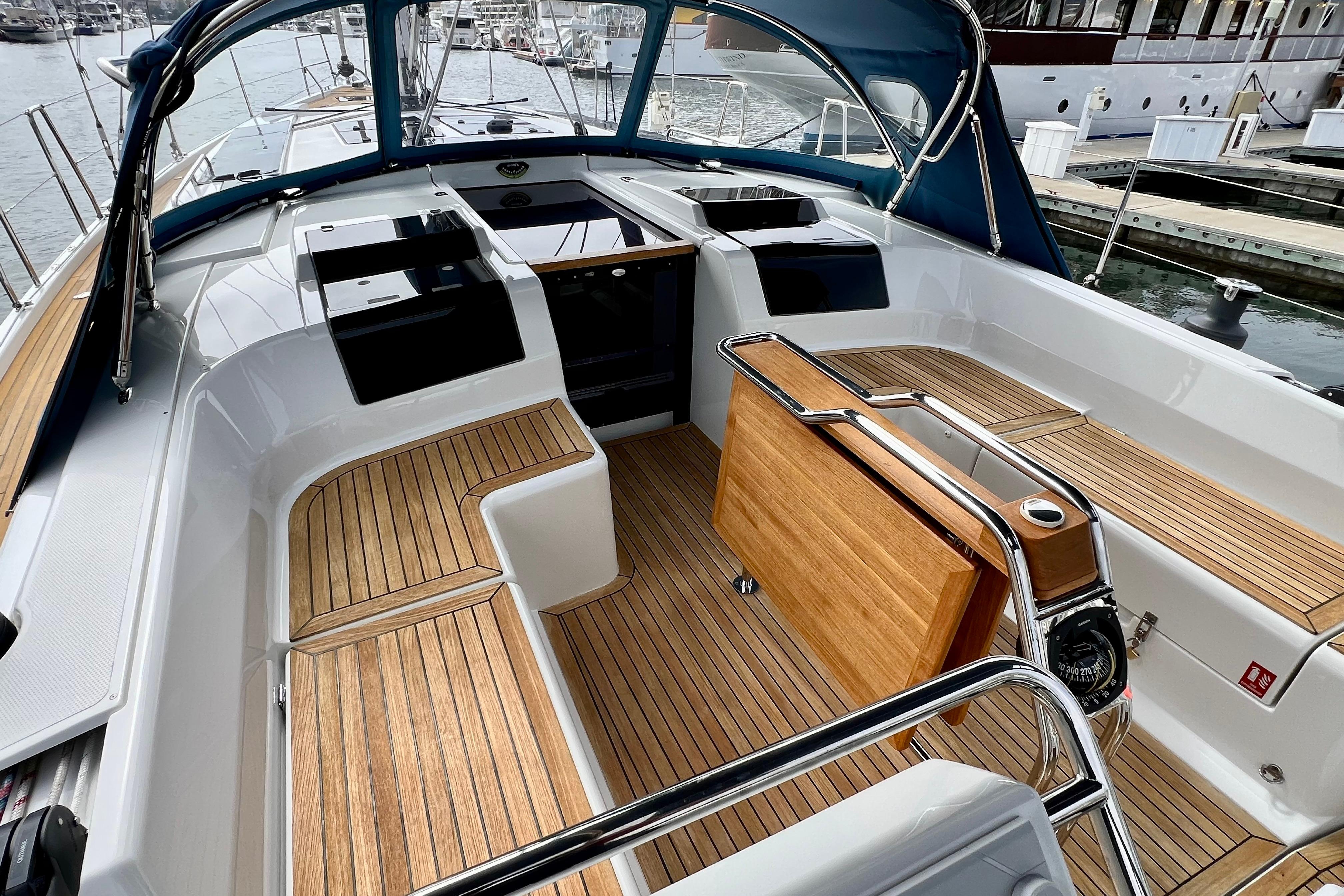 2016 Hanse 455 yacht cockpit with teak flooring and sleek design at marina.