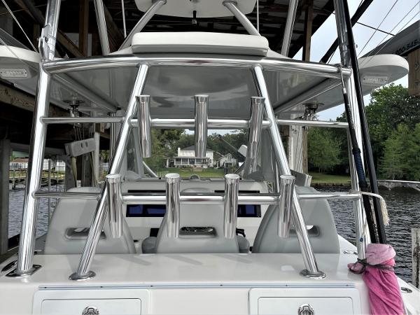 2020 Front Runner 39 Center Console boat with rod holders, docked near a waterfront home.