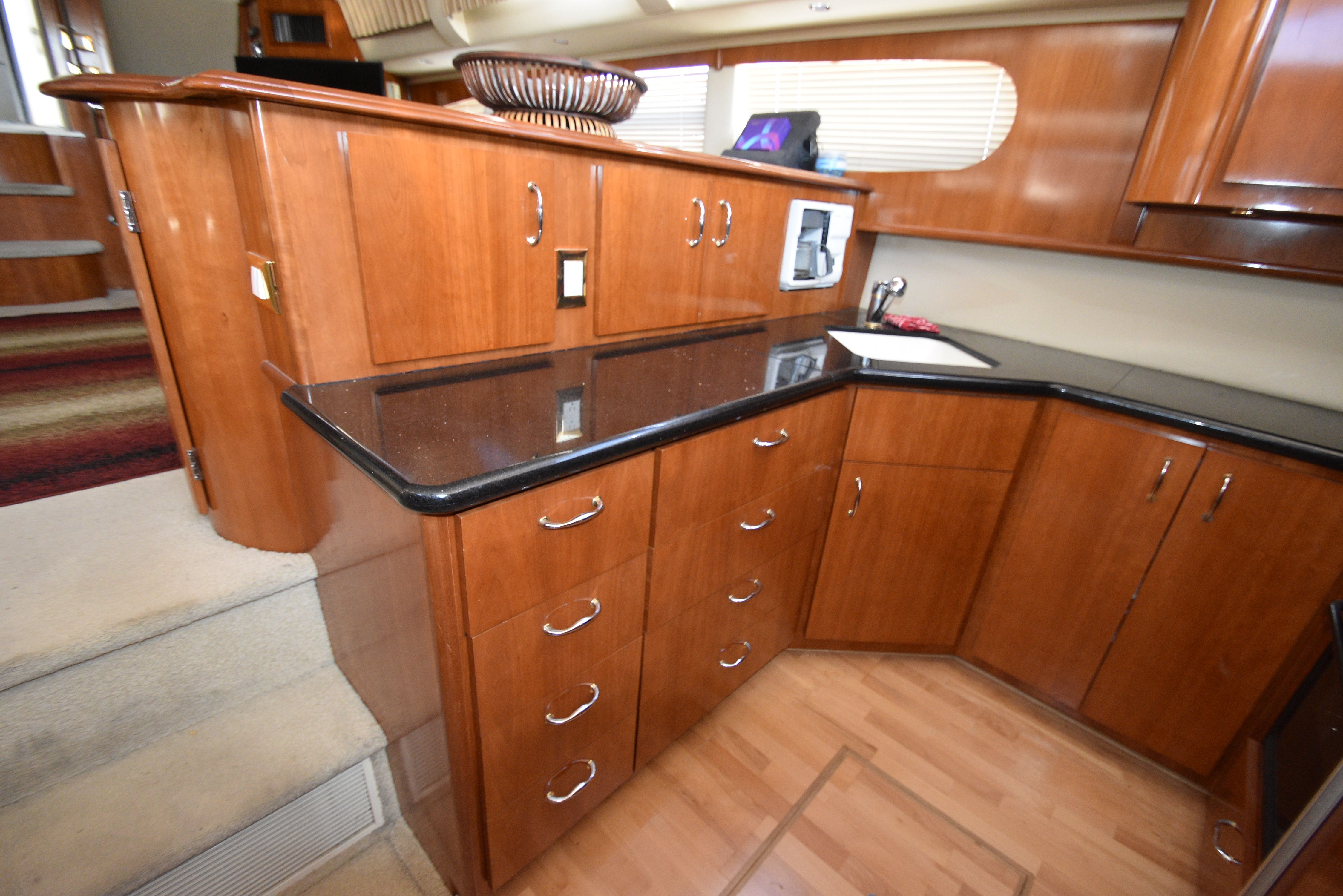 Interior of the 2004 Carver 466 Motor Yacht with elegant wood cabinets and countertops.