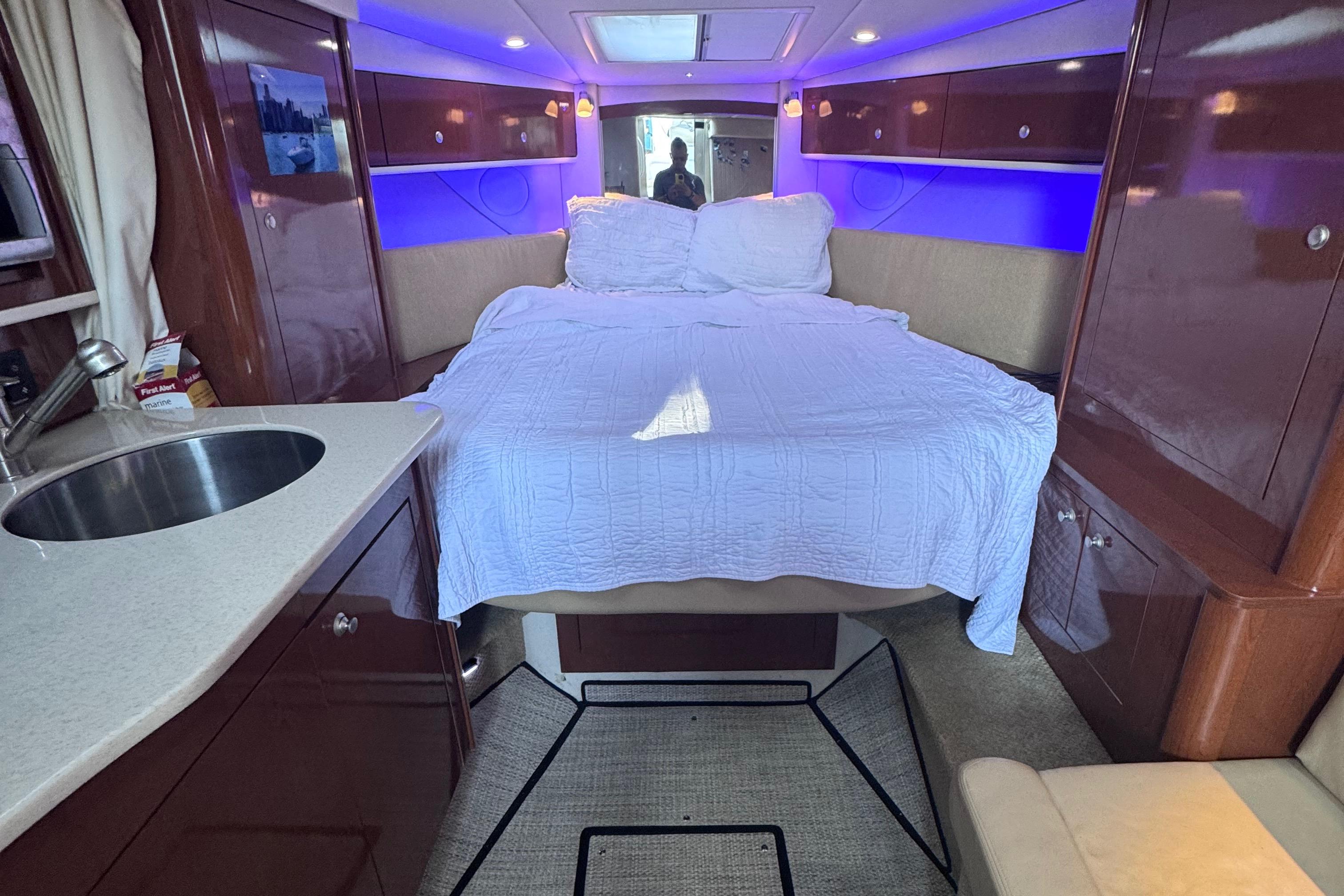 Interior of 2008 Sea Ray 350 Sundancer with bed, sink, and ambient lighting.