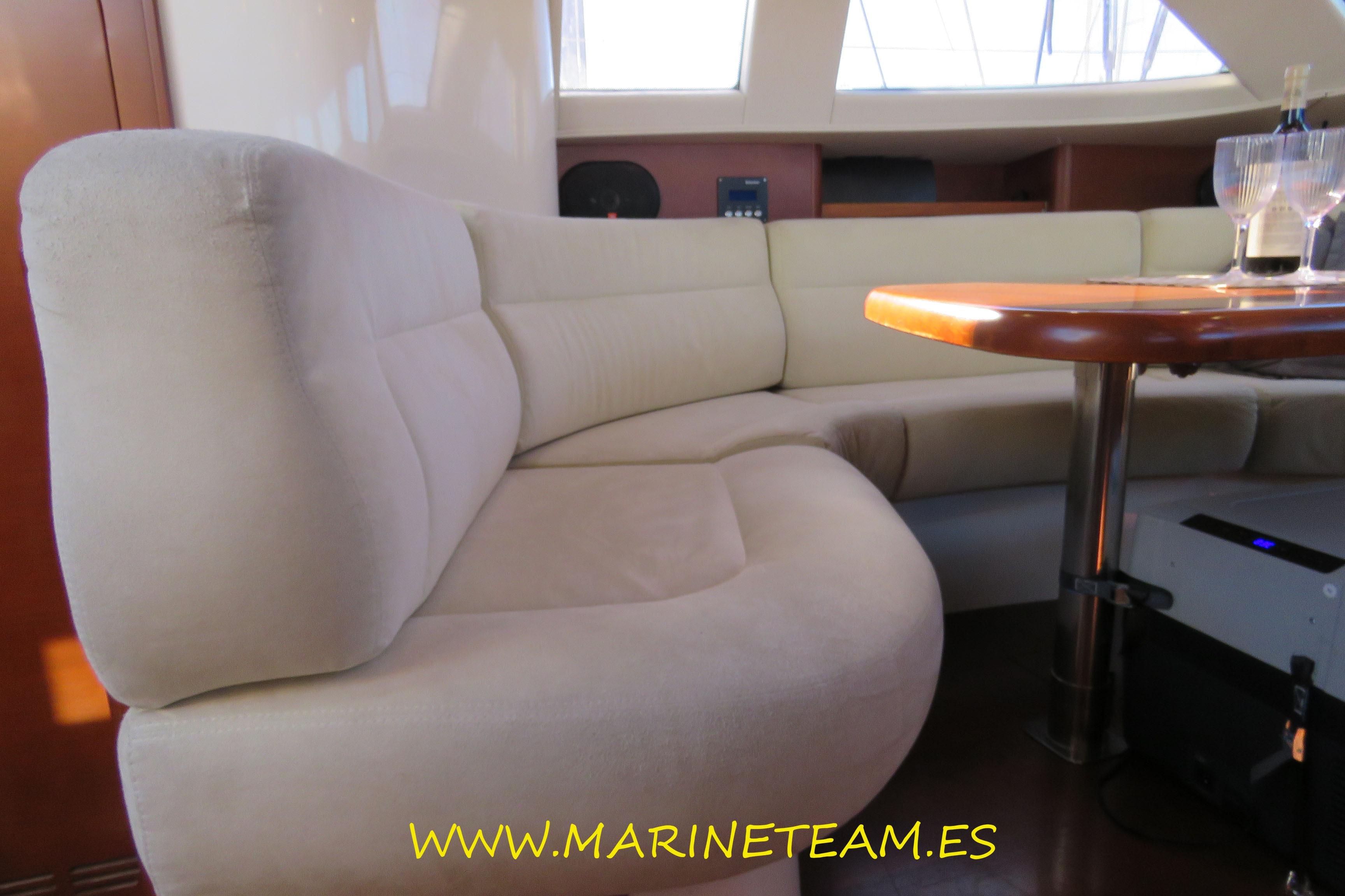 Luxurious interior of 2005 Shipman 50 yacht with plush seating and elegant table.