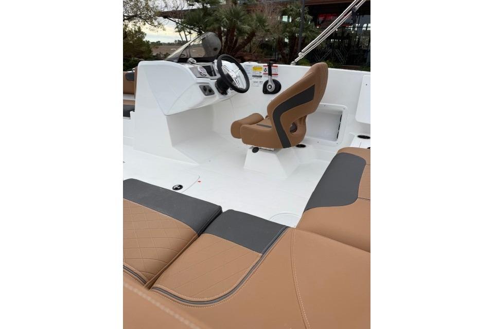 2026 Tahoe 1950 boat interior with tan and black seating, modern helm design.