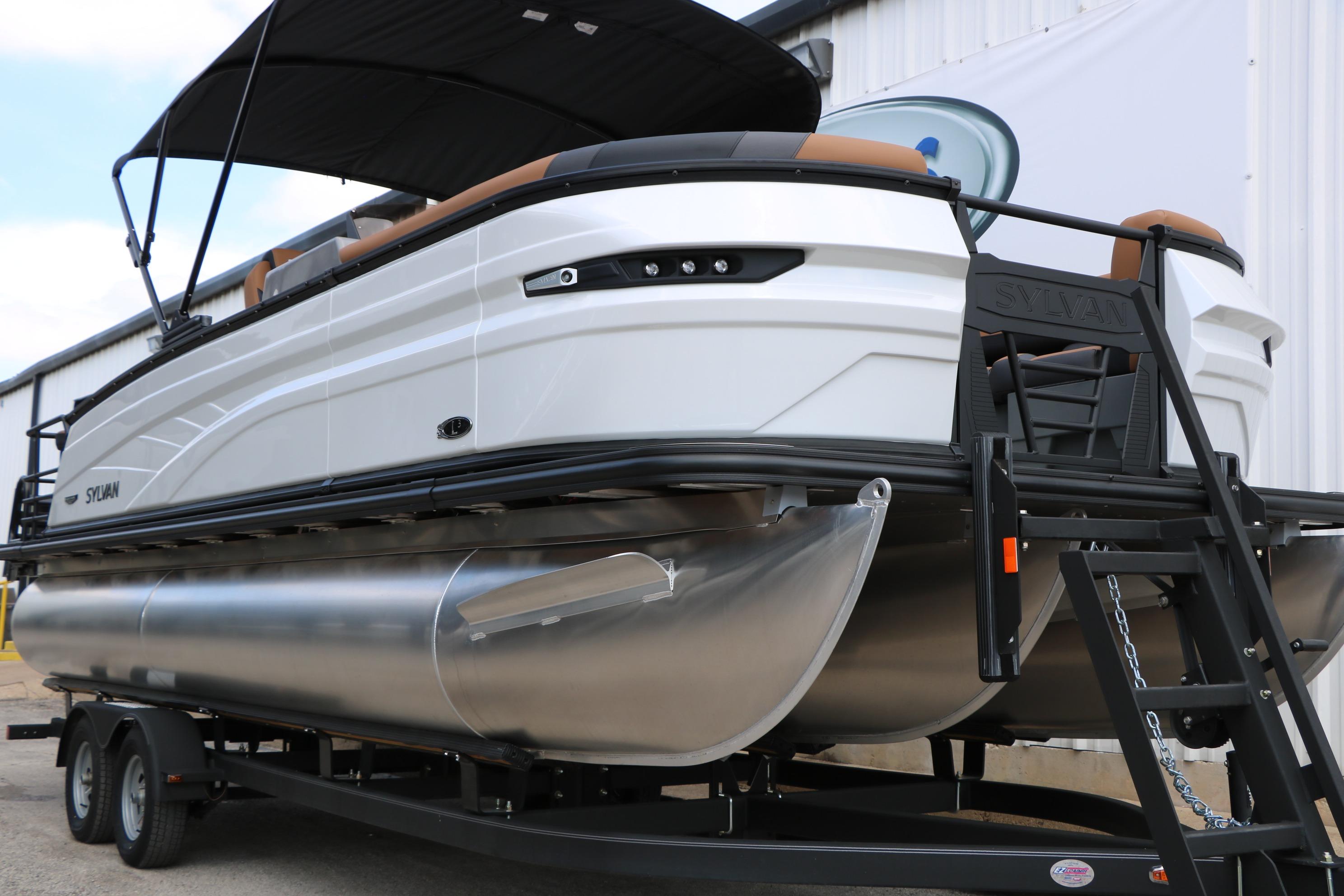 2026 Sylvan L3 DLZ Bar Platinum Edition Tri-Toon on trailer, showcasing sleek design.