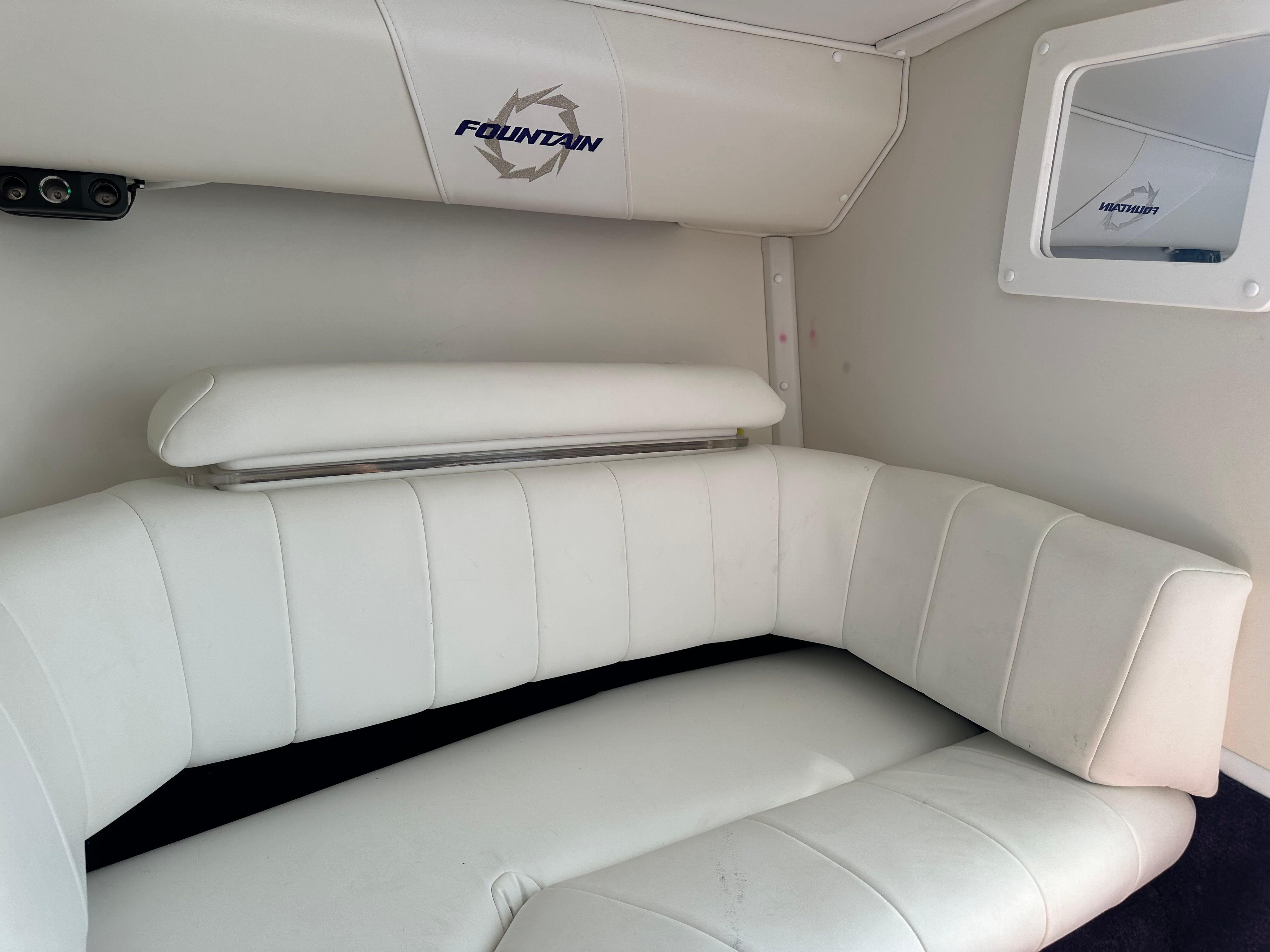 Interior of a 2006 Fountain 29 Fever with white upholstery and a small window.