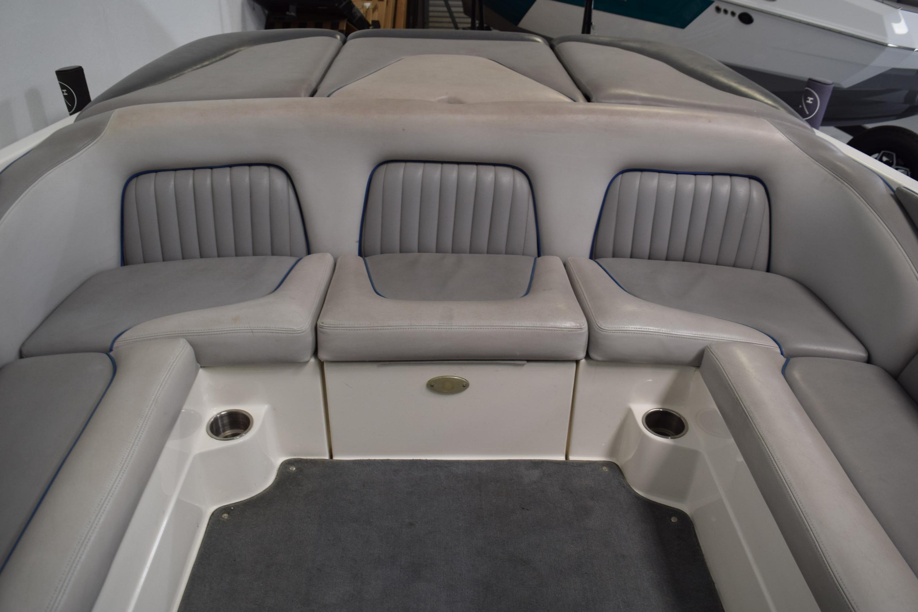 2007 Centurion SV 240 boat interior with gray cushioned seating and cup holders.