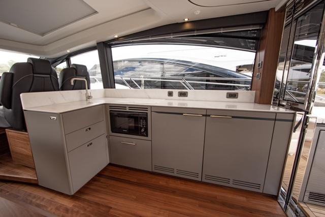 Modern kitchen interior on 2024 Princess V55 yacht with sleek cabinetry and appliances.