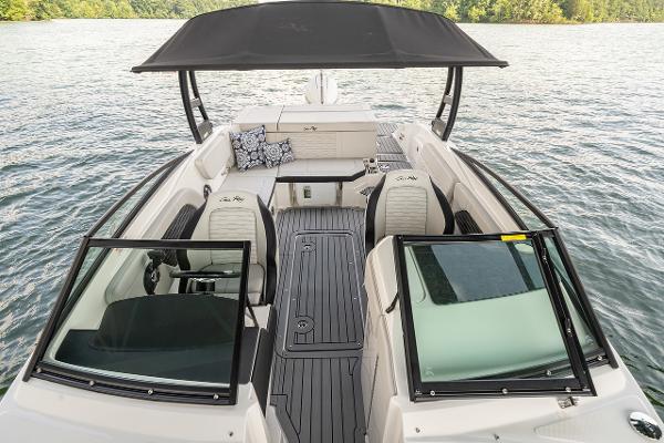 Manufacturer Provided Image: 2023 Sea Ray SPX 230 OB boat interior with seating and canopy on a lake.