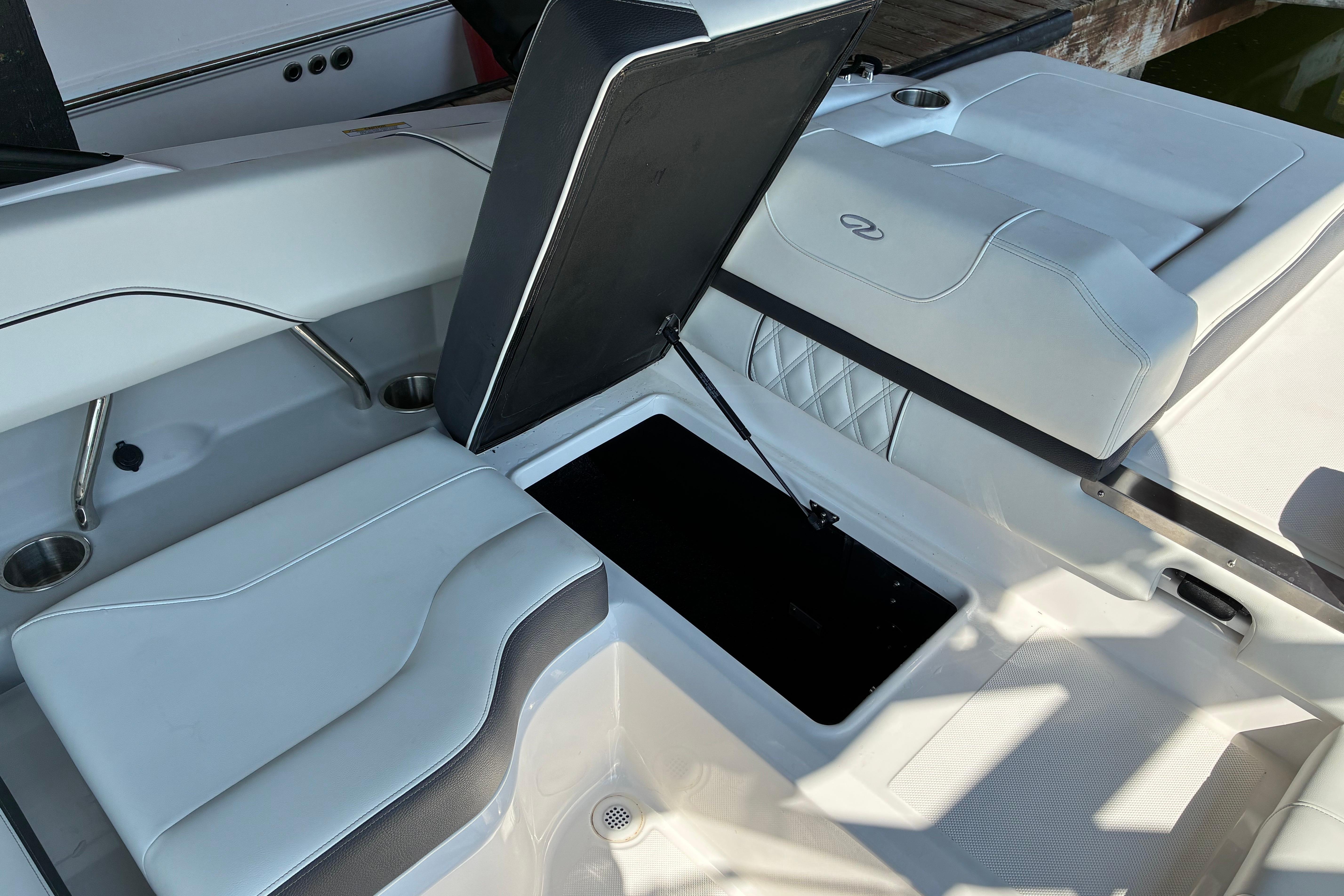 2025 Regal LS2 boat interior with open storage compartment and cushioned seating.