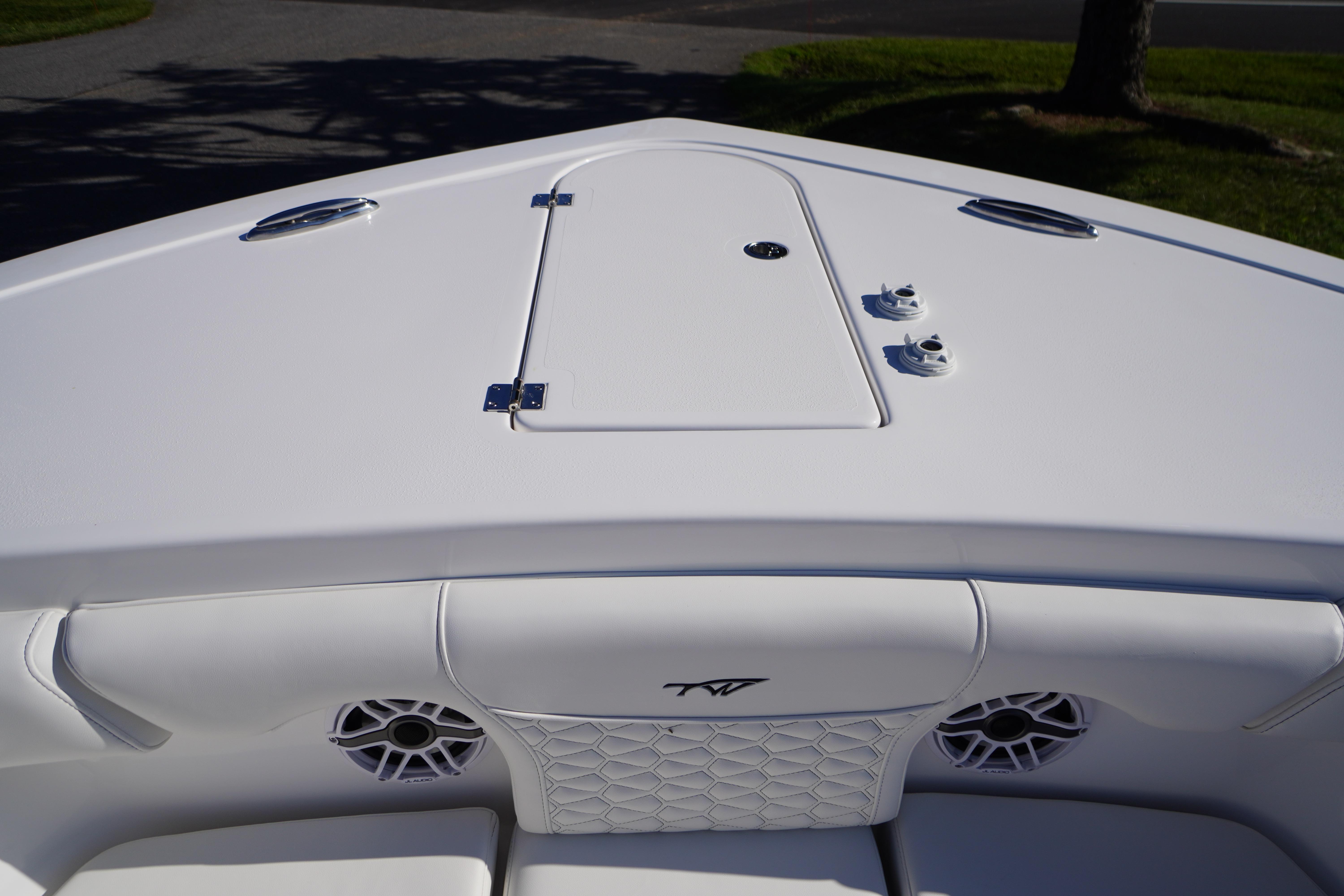 Bow view of 2026 Tidewater 272 LXF boat with sleek white design and speakers.