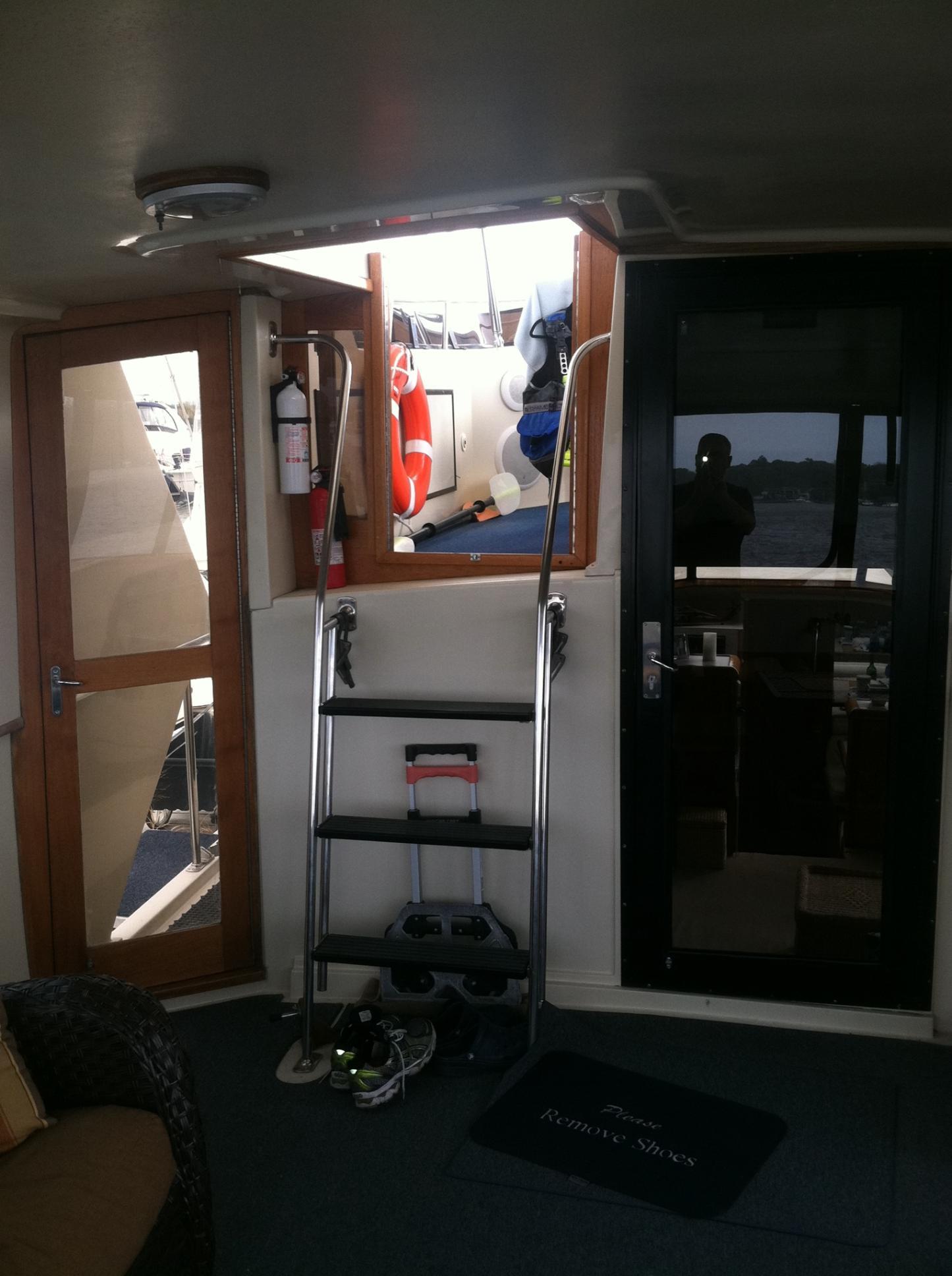 Interior view of 1989 Californian 48 Motor Yacht with open hatch and safety equipment.