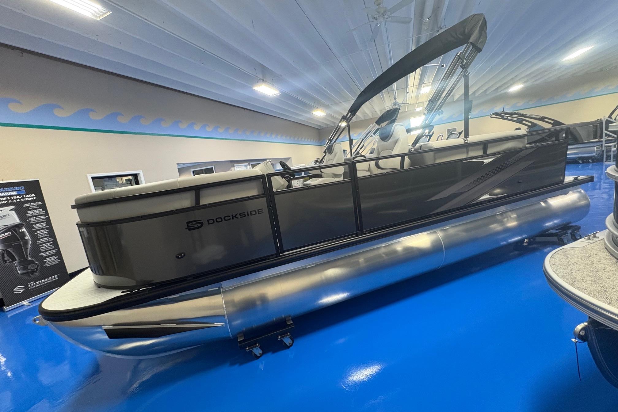 2026 Dockside 22DQ pontoon boat displayed indoors on a blue floor.