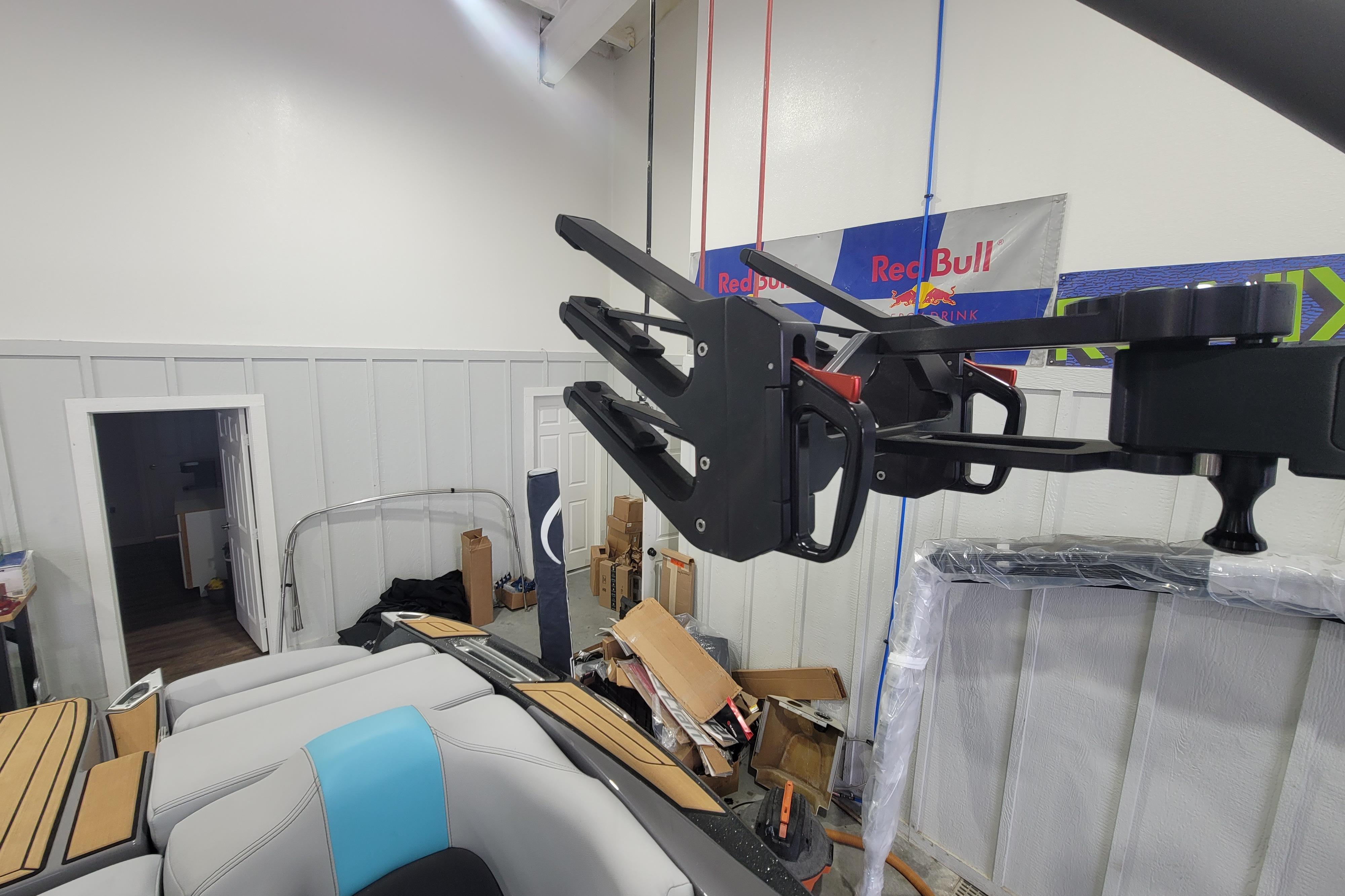 2022 MasterCraft X22 boat interior with wakeboard rack in a garage setting.
