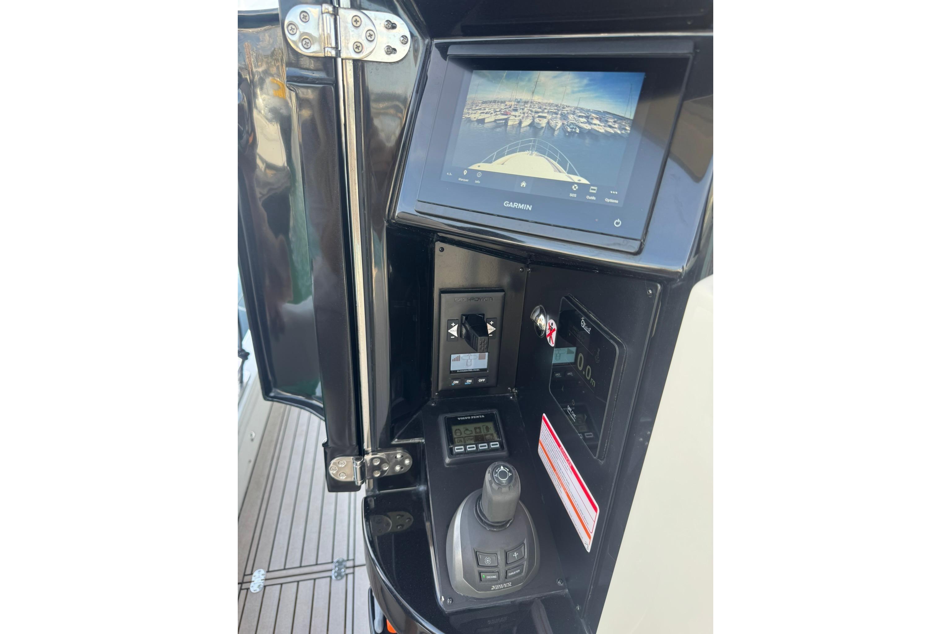 2024 Absolute Navetta 64 yacht control panel with Garmin display and joystick.