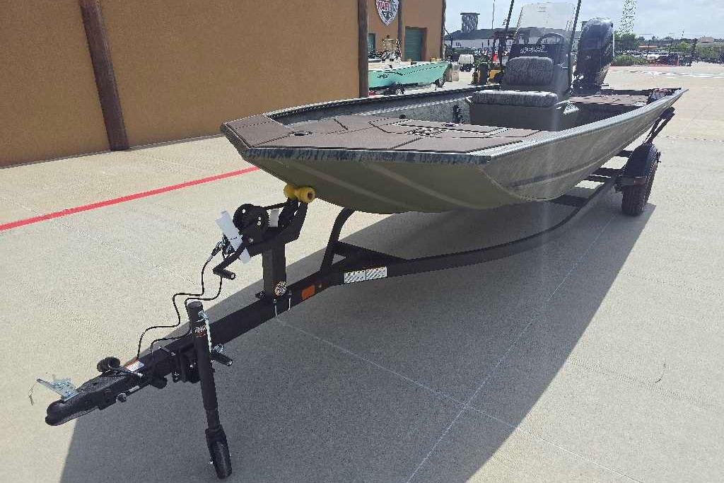 2026 Tracker Grizzly 1860 CC boat on trailer, parked outdoors.