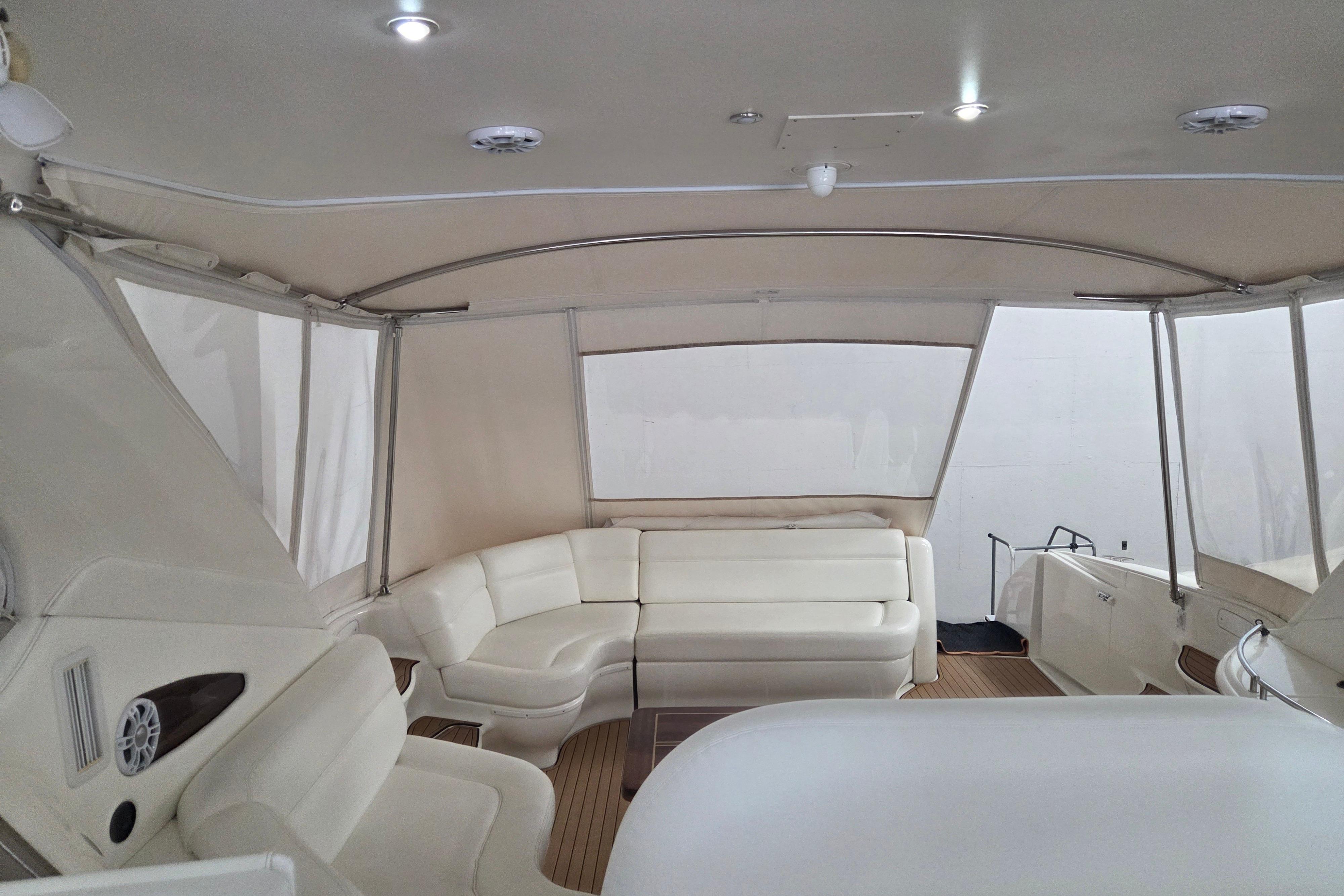 Luxurious interior of a 2000 Sea Ray Sundancer 540 yacht with white seating.