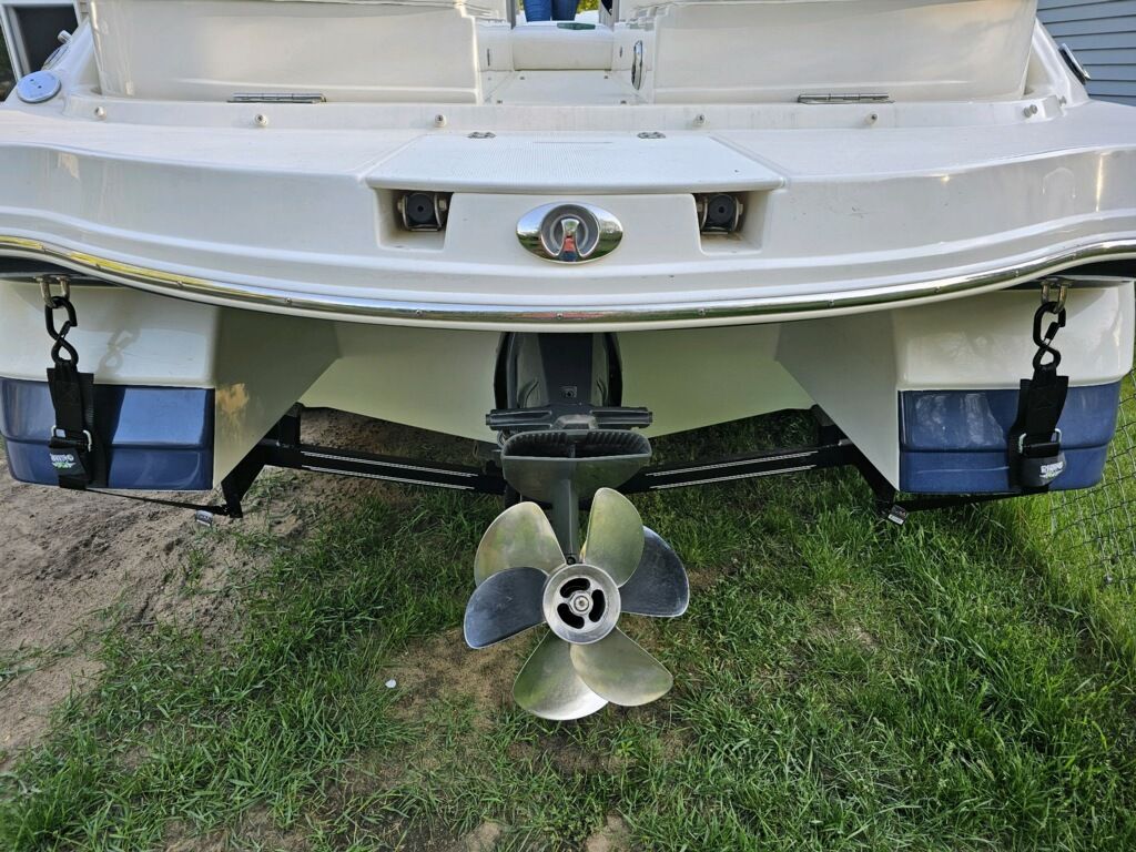 2009 Rinker Captiva DB boat hull with propeller on grass.