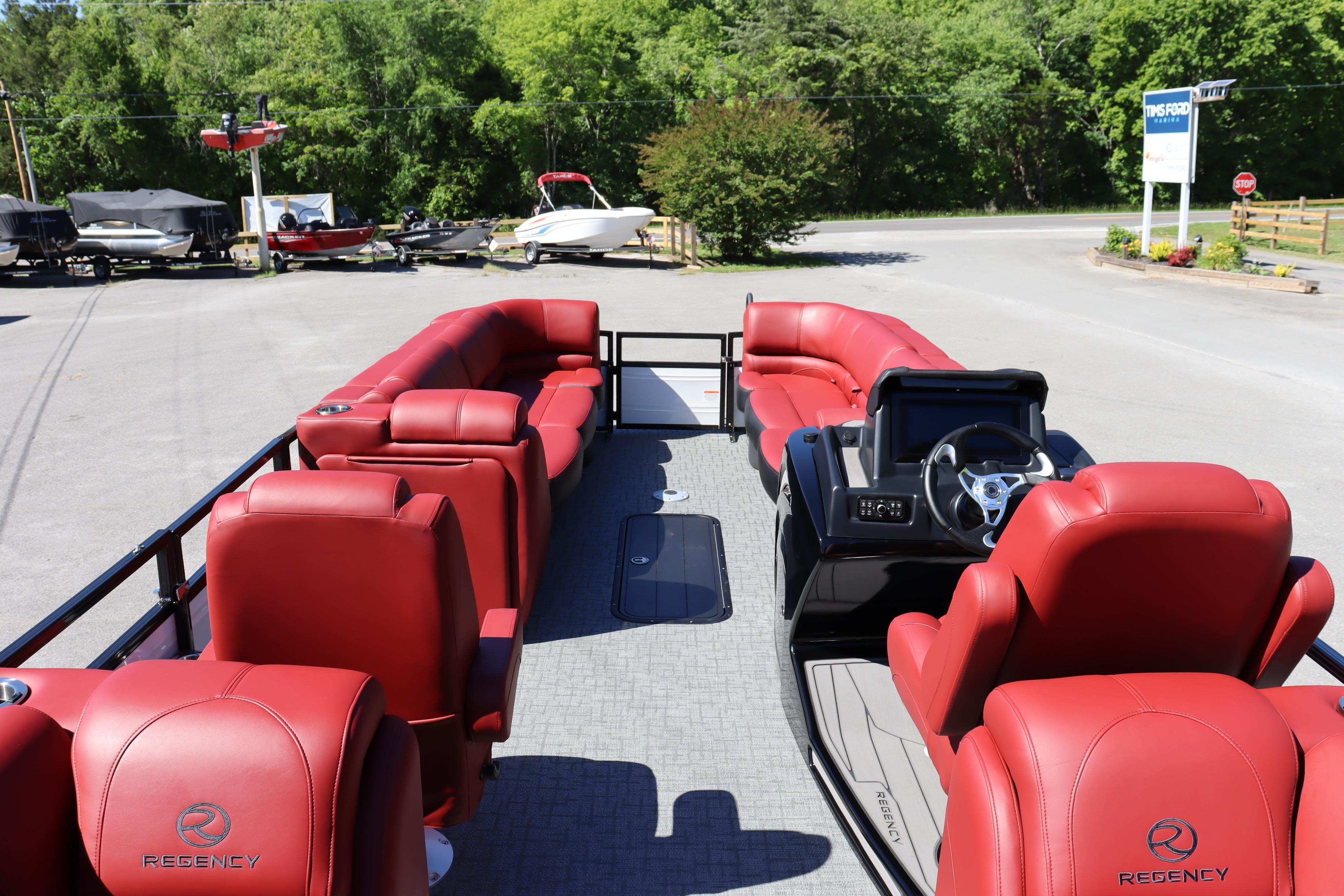2026 Regency 250 DL pontoon boat with luxurious red seating and modern helm.
