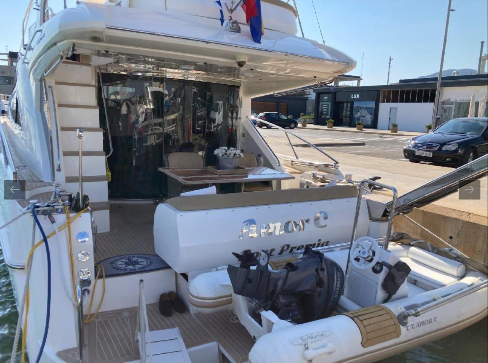 2005 Sealine T60 yacht docked, featuring spacious deck and inflatable boat.