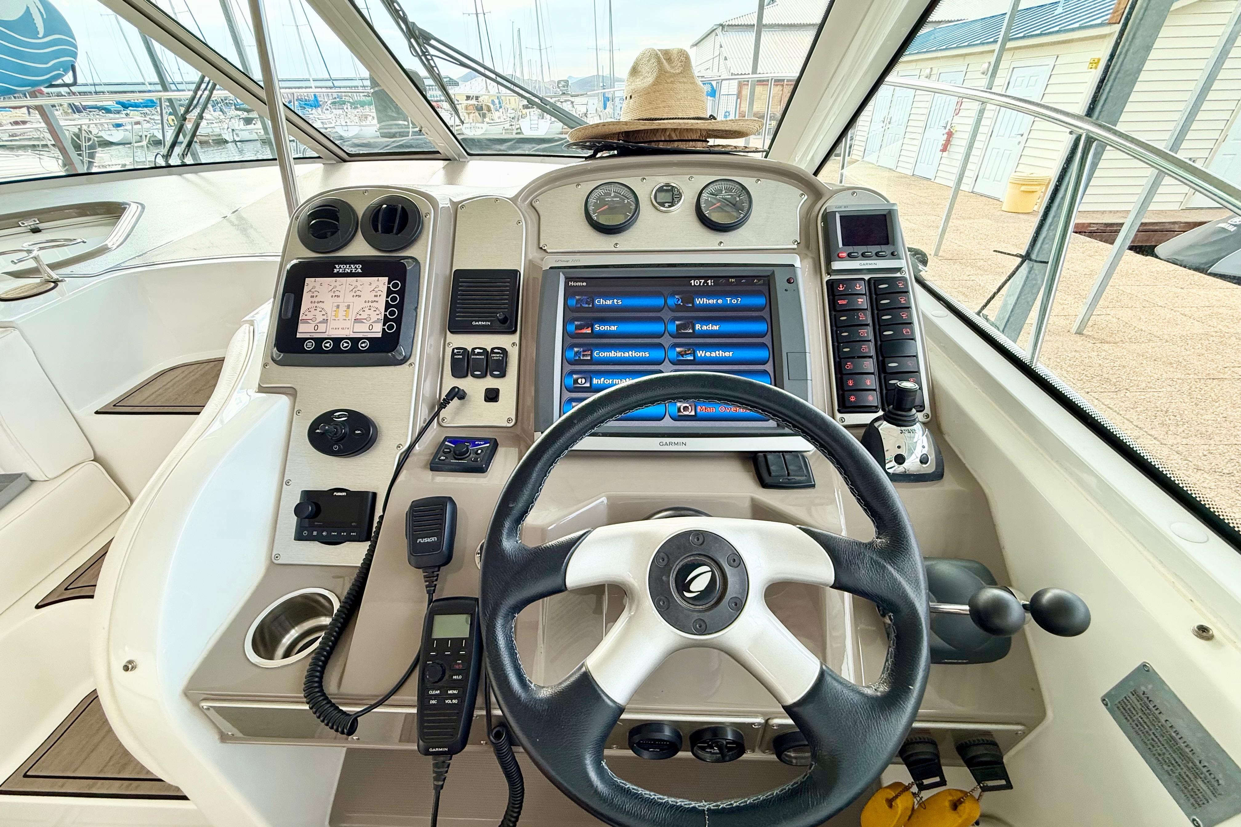 Cockpit of 2011 Cruisers Yachts 390 Sports Coupe with navigation controls and steering wheel.