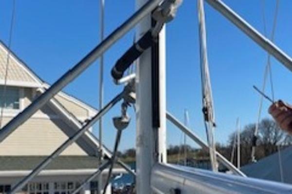 Mast rigging on a 1989 Catalina 30 sailboat against a clear blue sky.