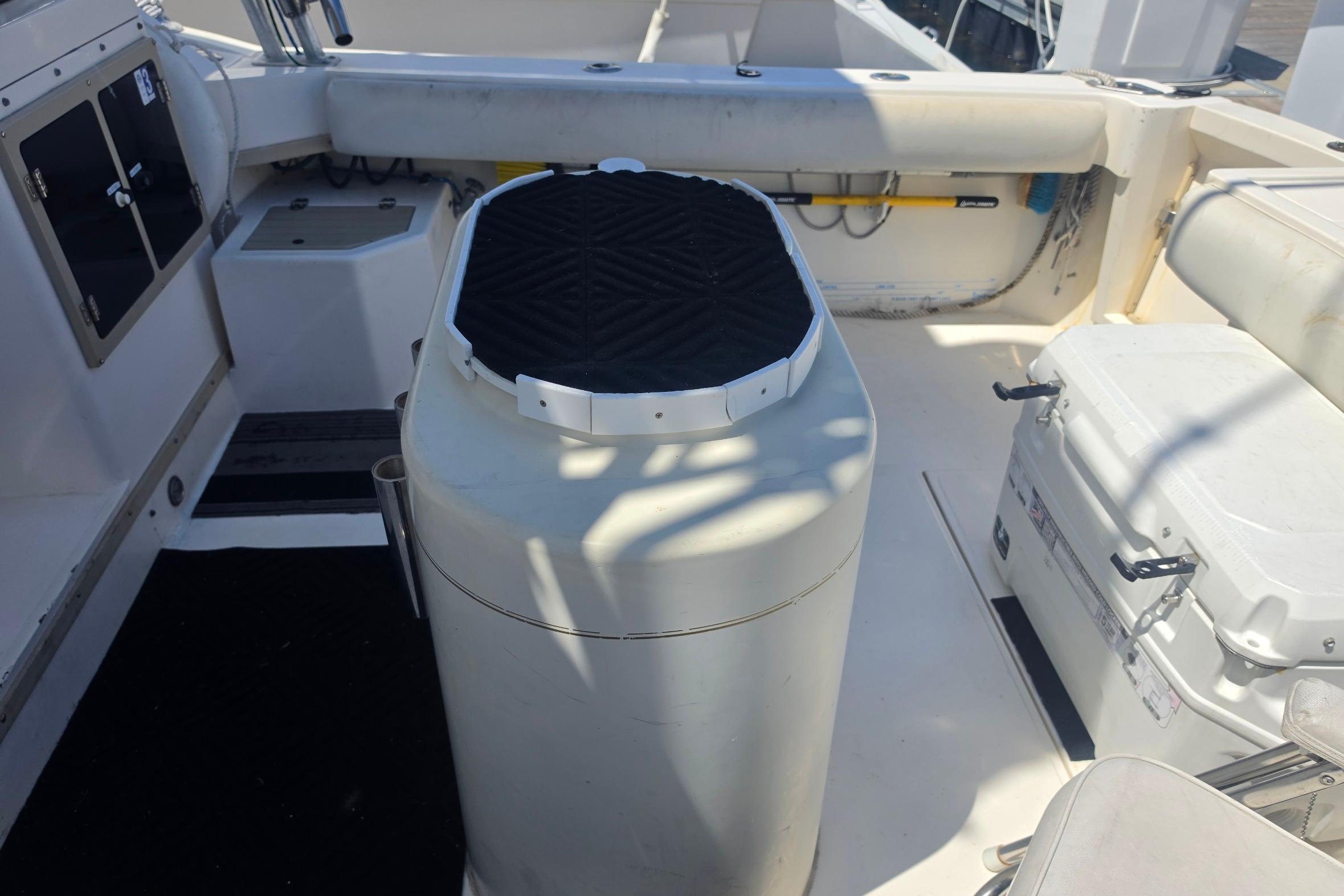 1999 Albemarle 305 Express Fisherman boat interior with seating and storage compartments.