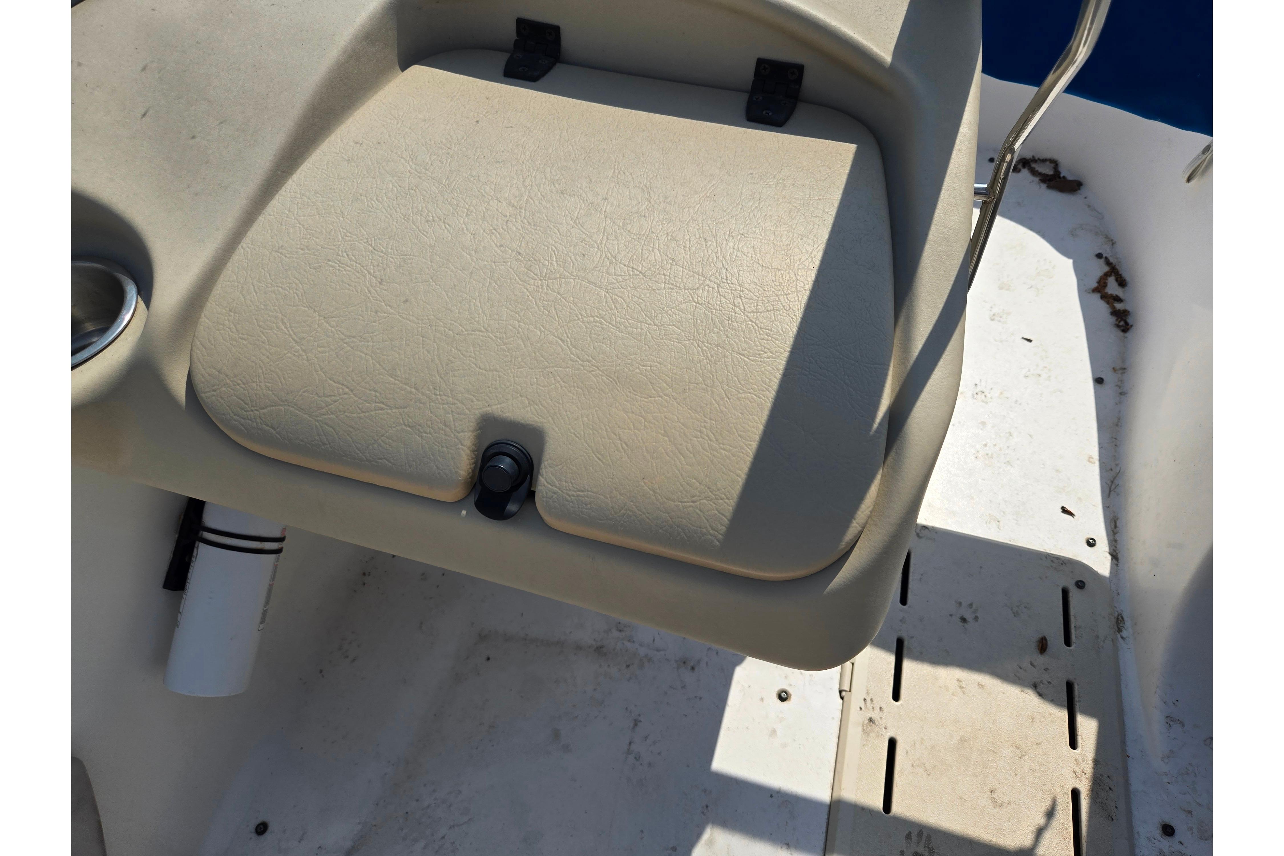 2007 Glastron GT 185 boat seat and deck, featuring beige upholstery and cup holder.