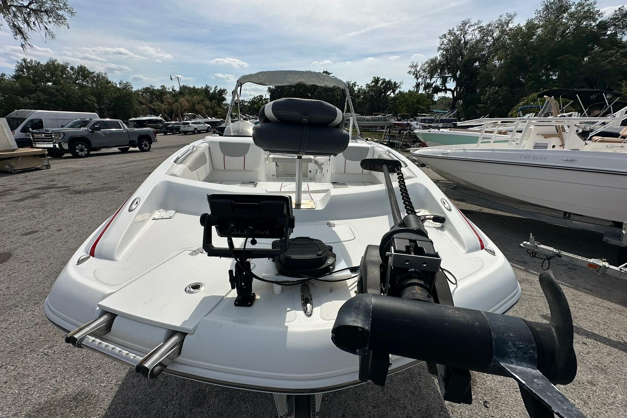 2021 Tahoe 2150 boat with seating and equipment, parked in a marina.