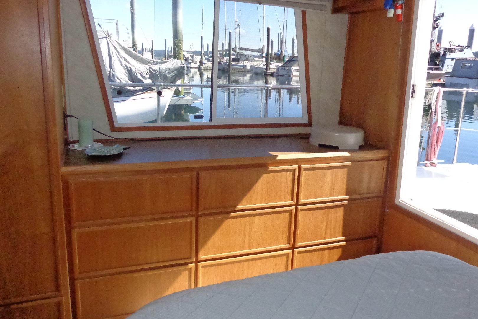 Interior of 1992 Cruise-A-Home Corsair 4200 with wooden cabinetry and marina view.