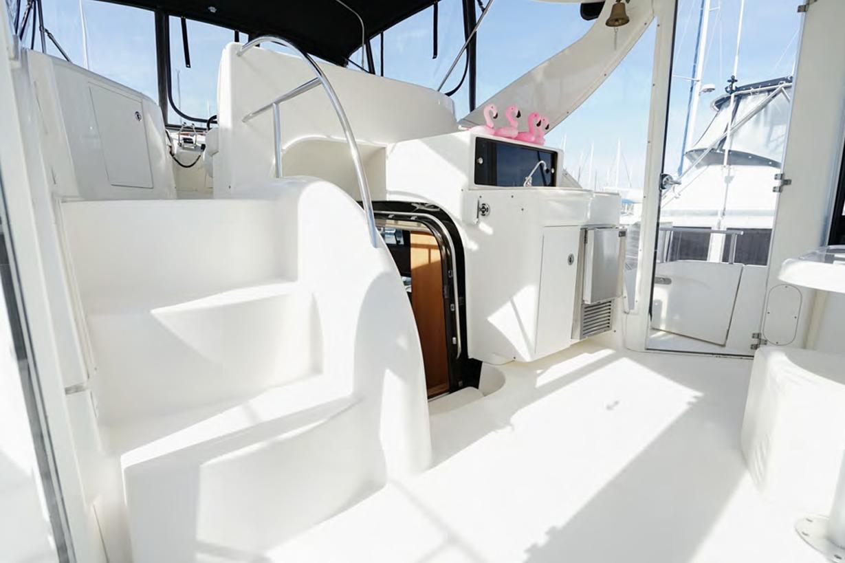 2004 Meridian 459 Motoryacht interior with stairs, kitchenette, and bright white finish.