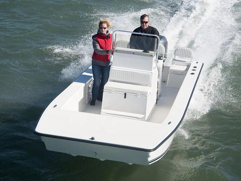 2024 KenCraft 2060 Bay Rider Skiff cruising on water with two passengers.
