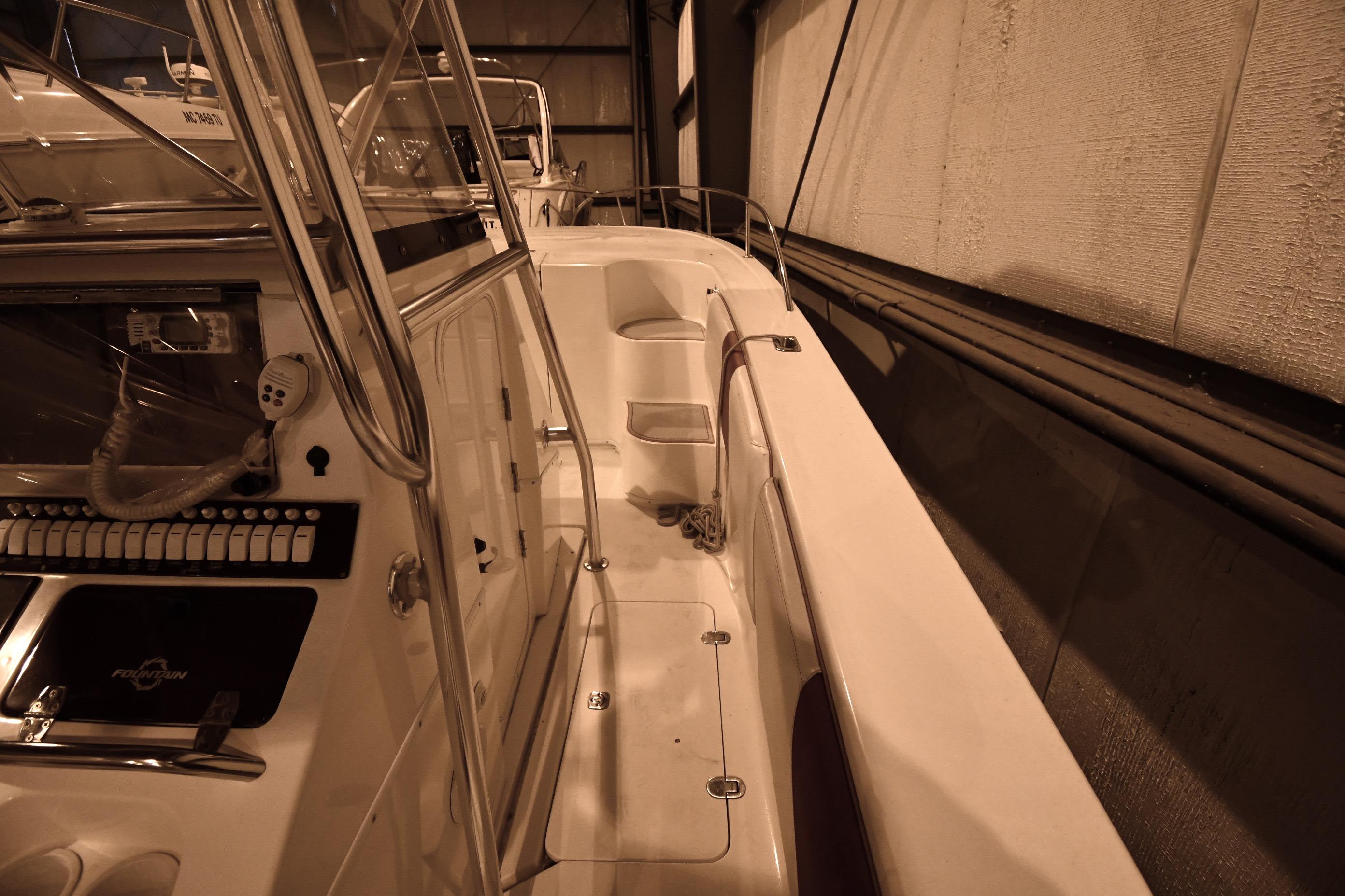 2001 Fountain 38 Center Console boat interior with control panel and seating.