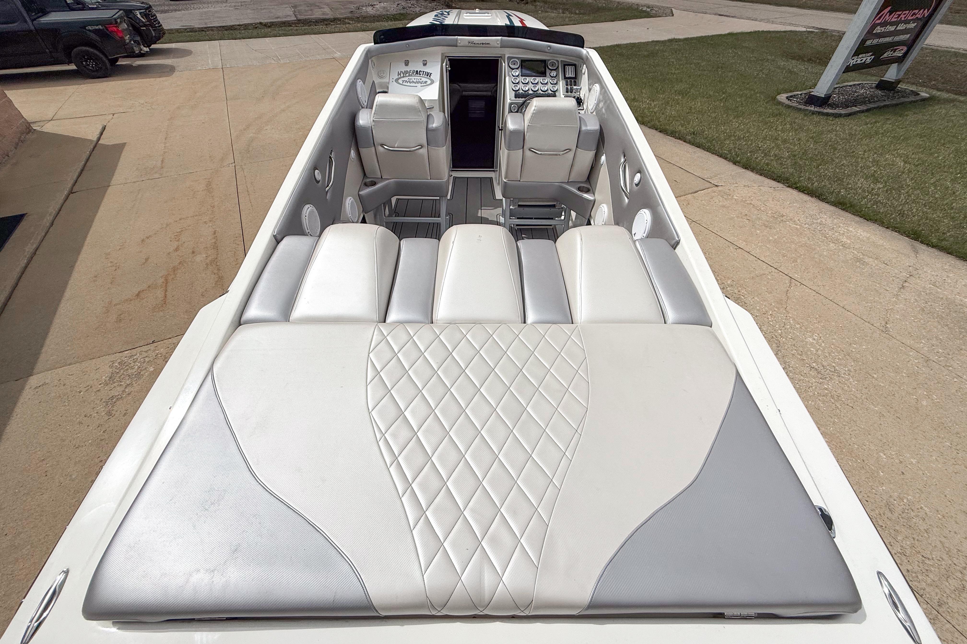 2002 Active Thunder 37 boat interior with sleek white and gray seating design.