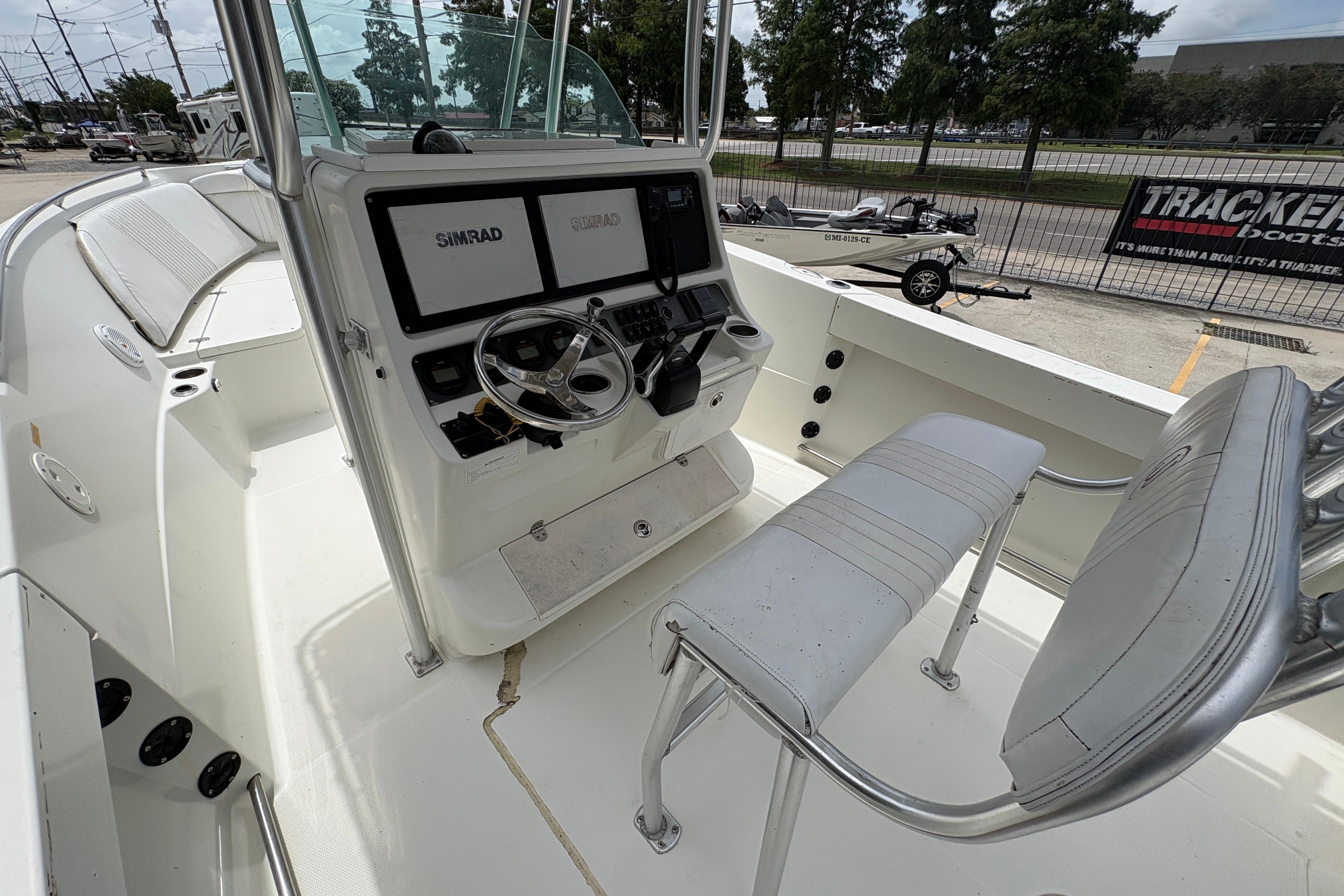 2006 Sail Faish 2360 boat cockpit with steering wheel and Simrad navigation system.