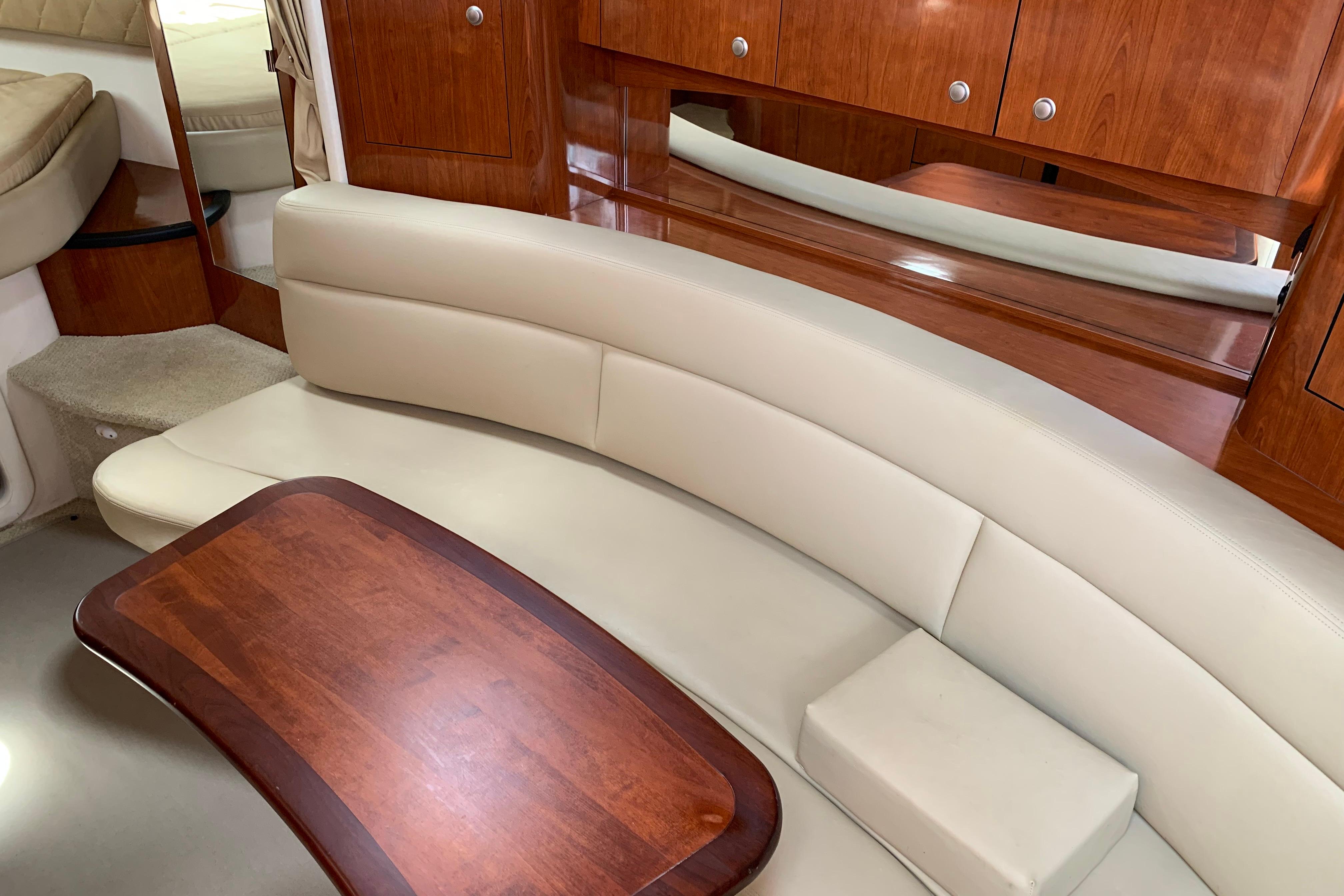 Luxurious interior of 2007 Sea Ray 340 Sundancer with elegant seating and wooden table.