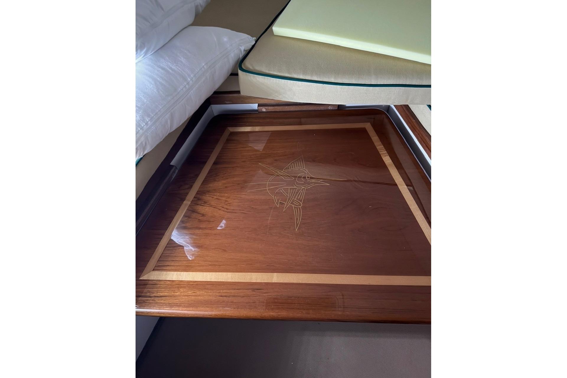 Wooden table with marlin inlay on 2000 Pursuit 3070 Offshore Center Console boat.