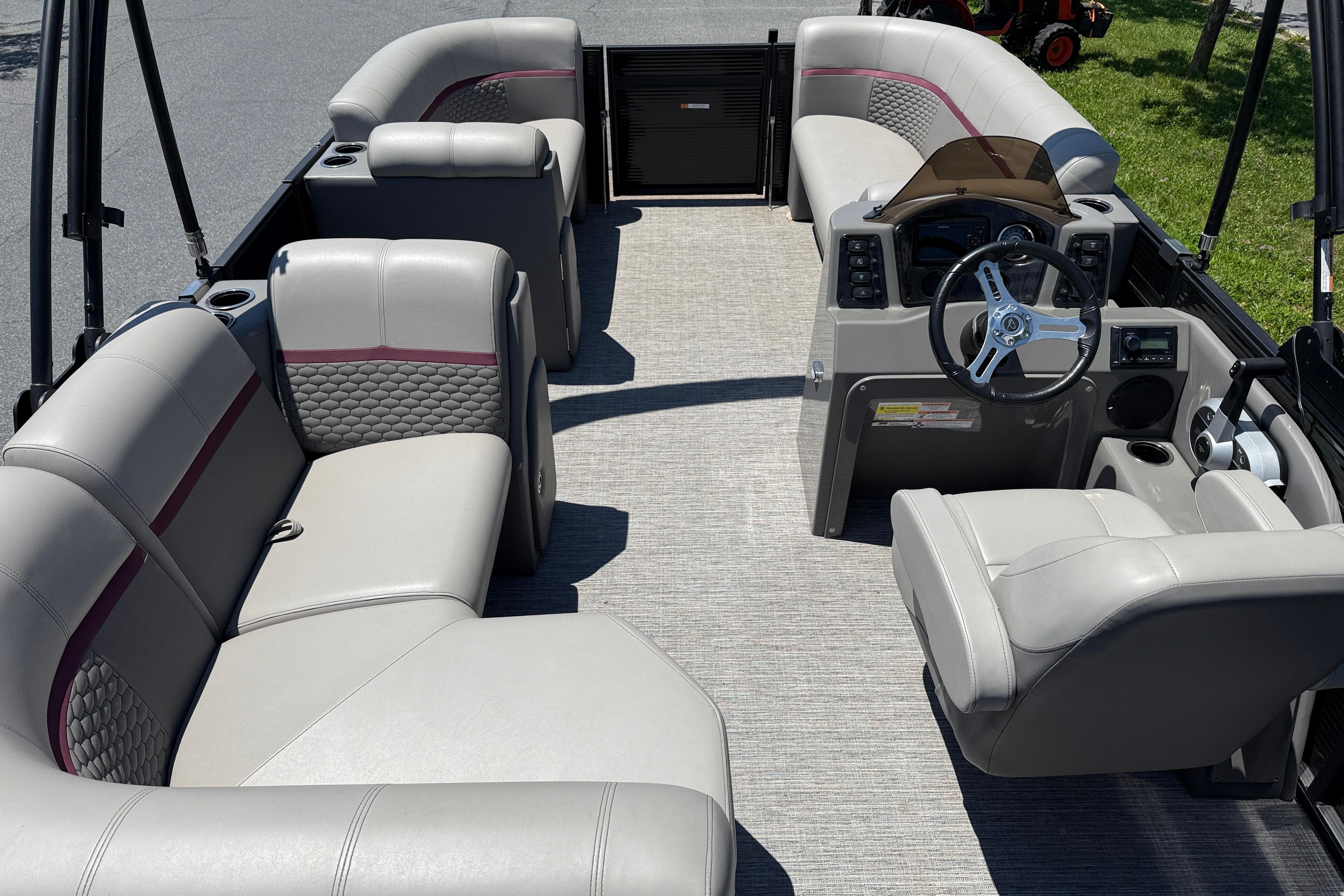 Luxurious interior of 2023 Apex 818 pontoon boat with plush seating and modern dashboard.